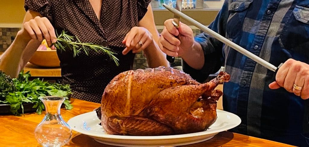 a woman holding a plate of food on a table