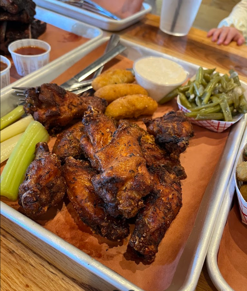 a person sitting at a table with a plate of food