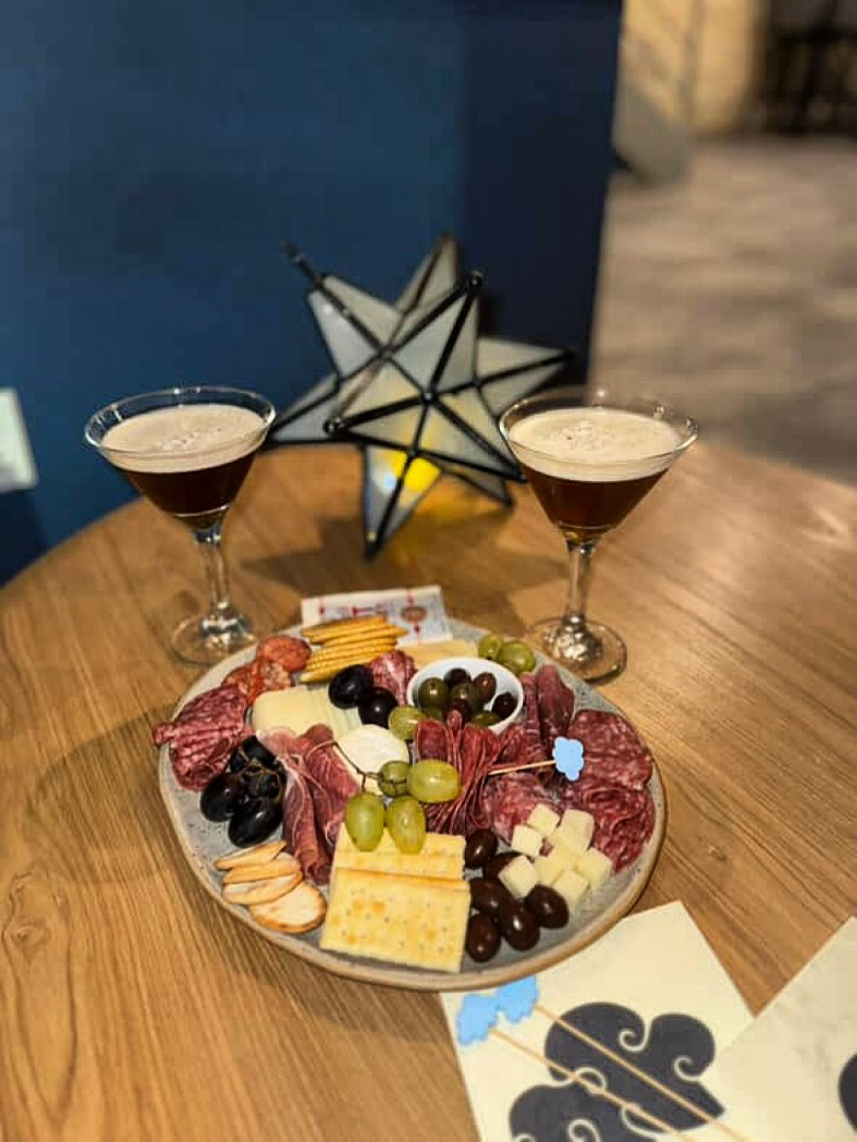a plate with a glass of wine sitting on top of a wooden table