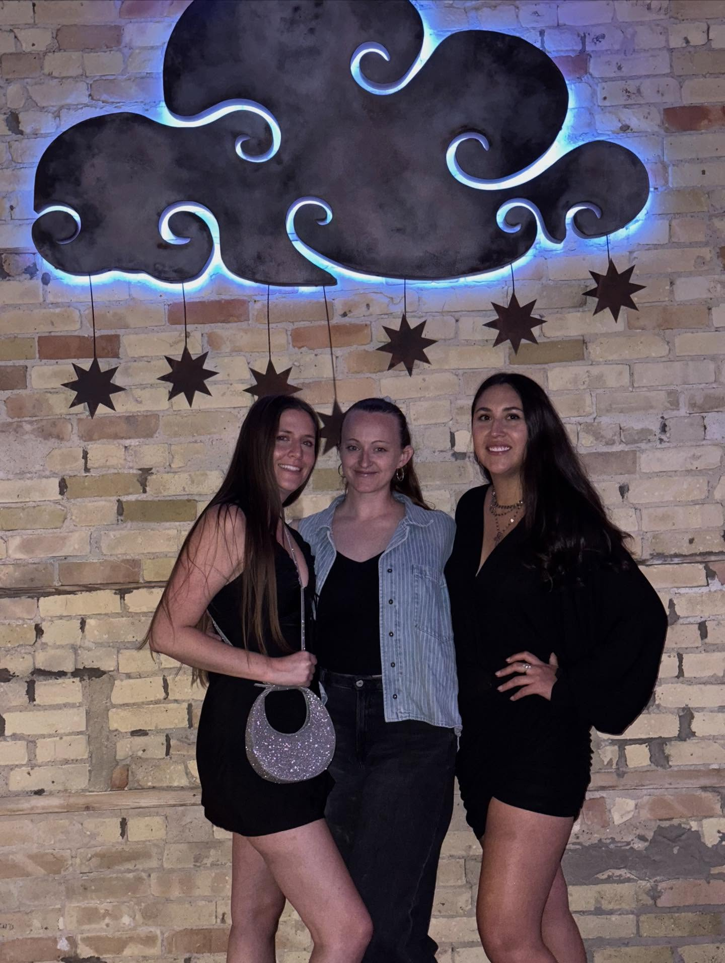 a person standing in front of a group of people posing for the camera