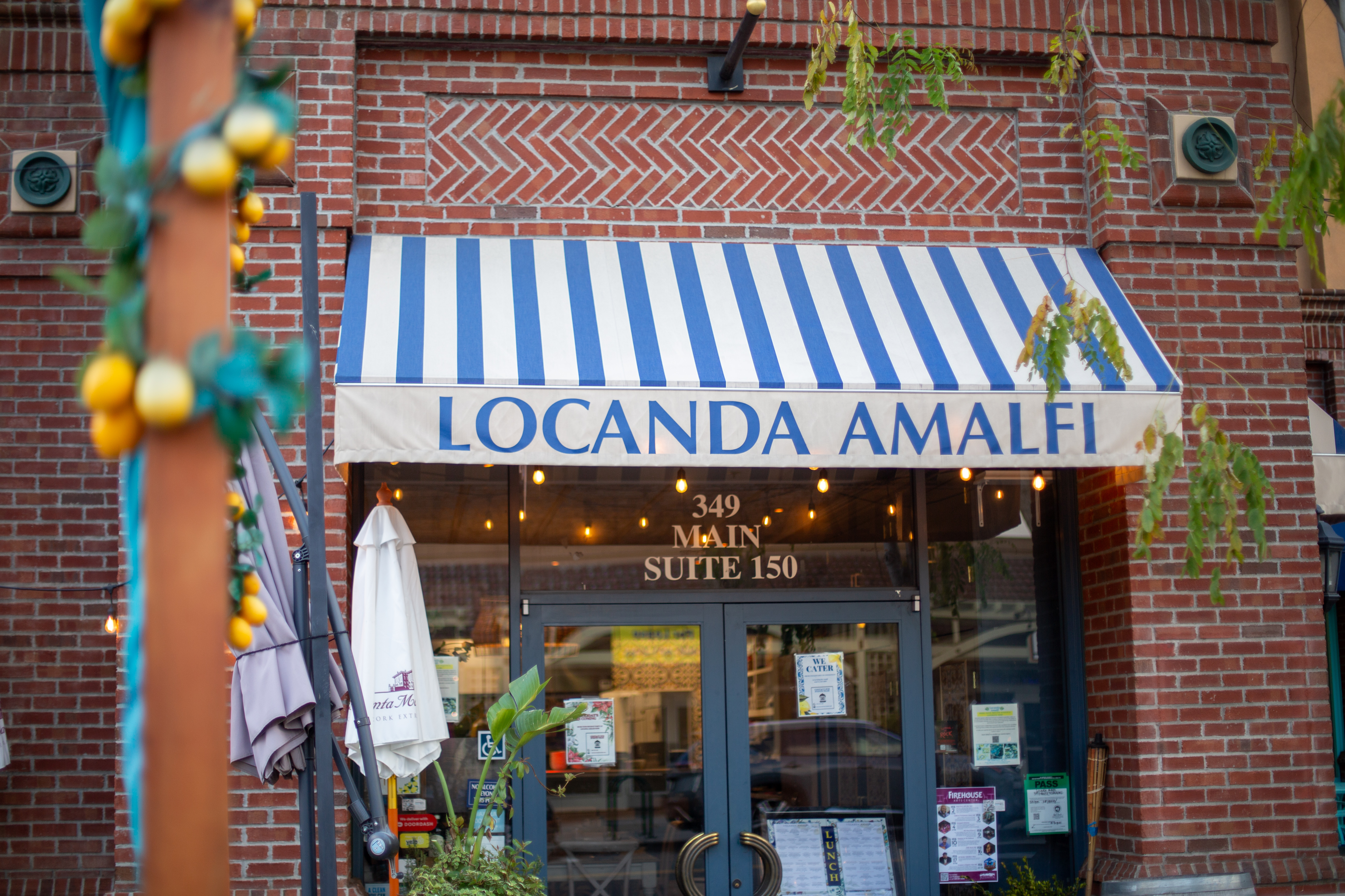 a brick building with a blue and white striped awning