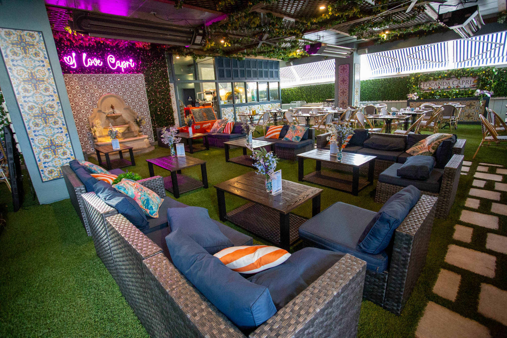 a restaurant with tables and seats on a patio