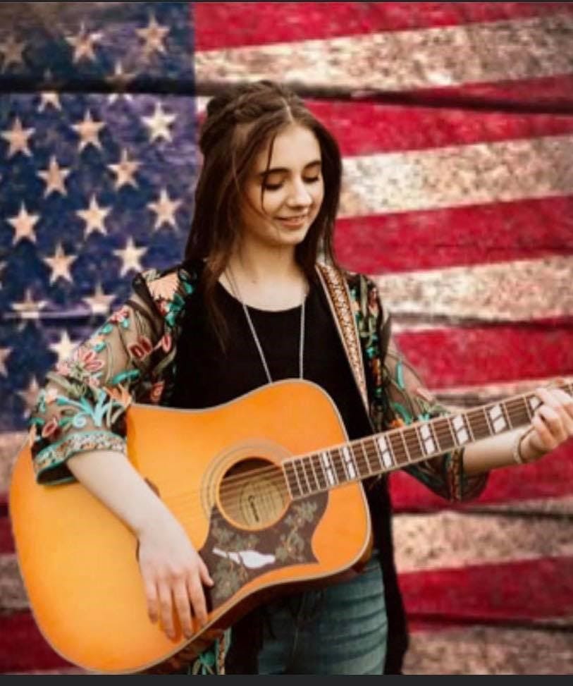 a woman holding a guitar