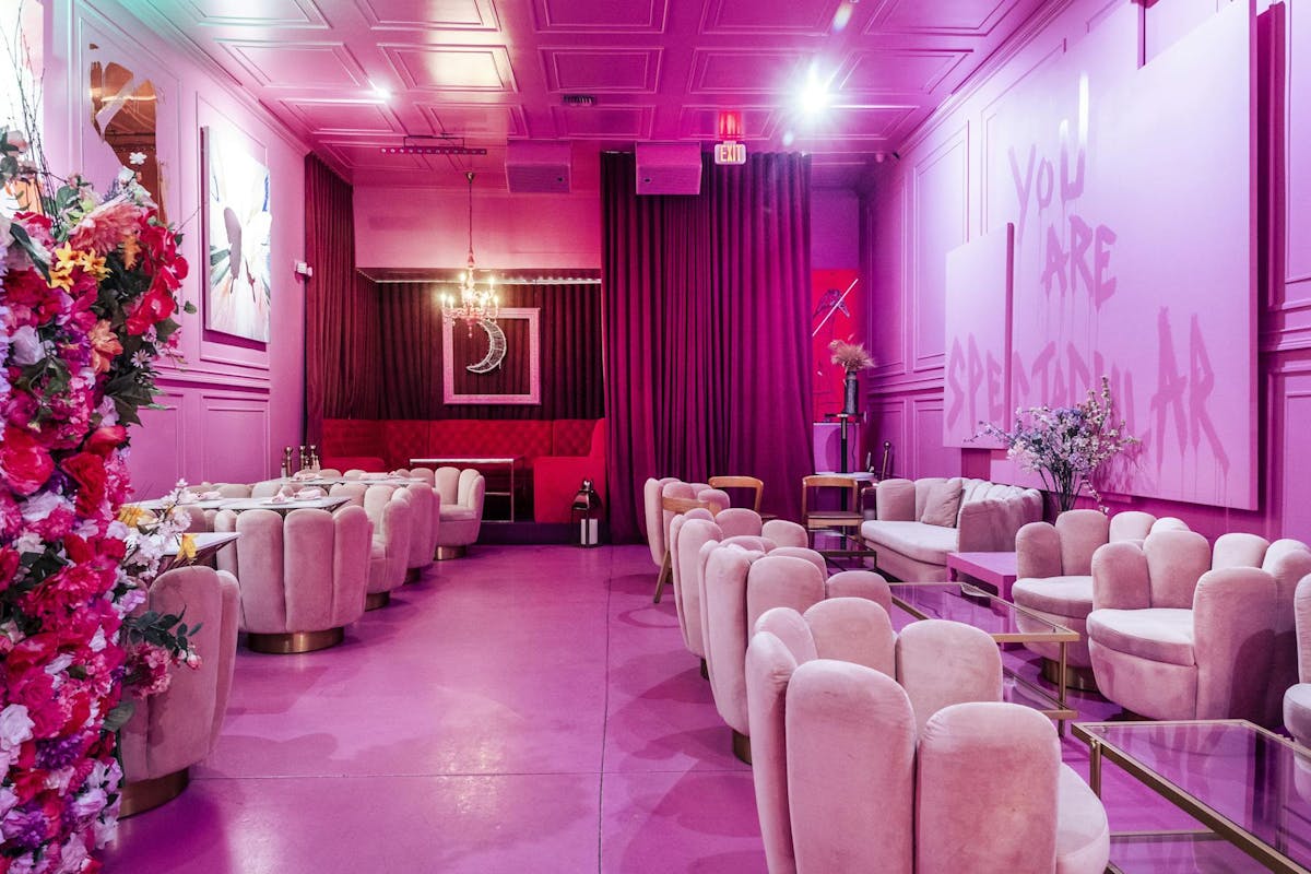 a room filled with pink flowers on a table