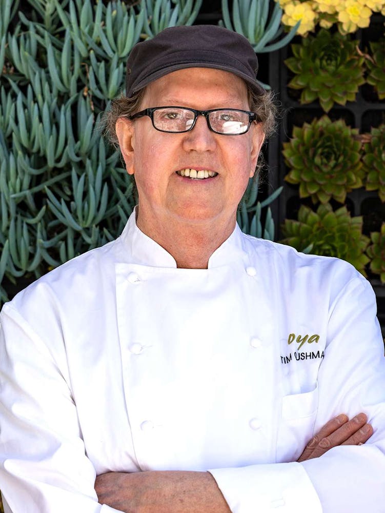 a man standing in a kitchen preparing food