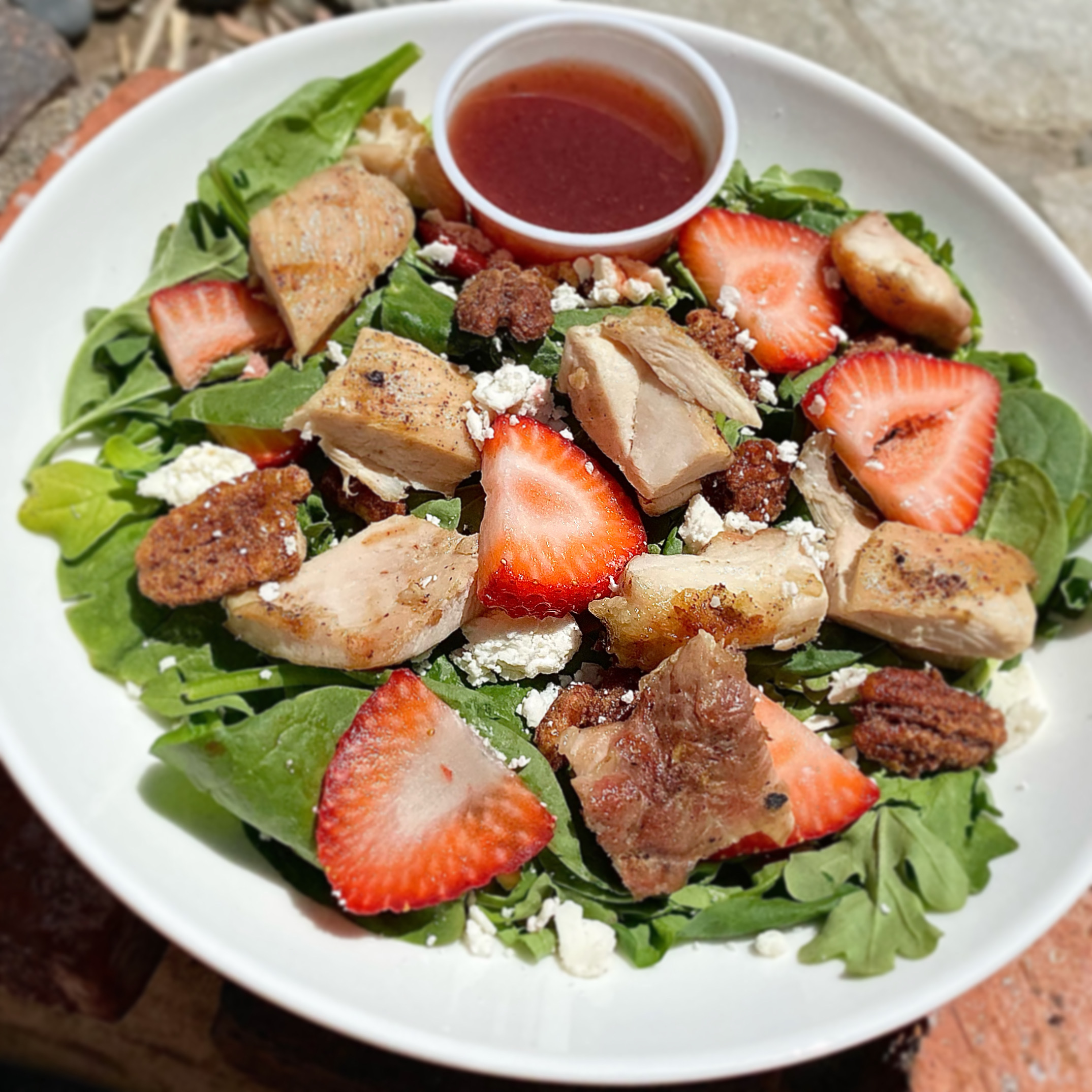 a salad with strawberries and cheese