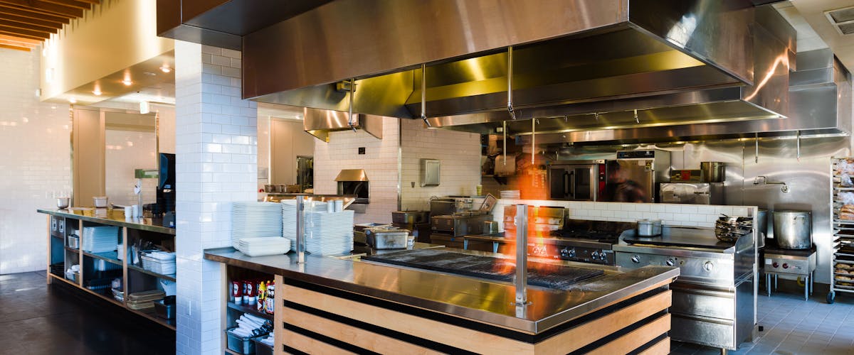 a large commercial kitchen with stainless steel appliances