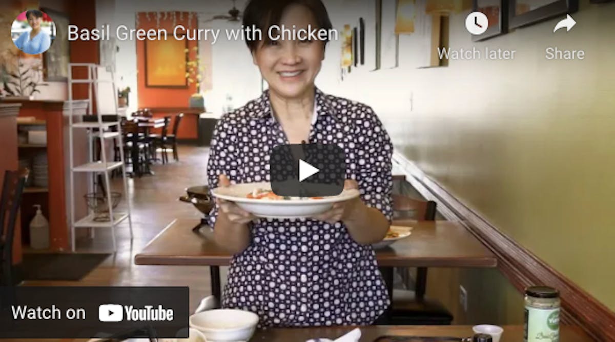 a woman cooking food at a table