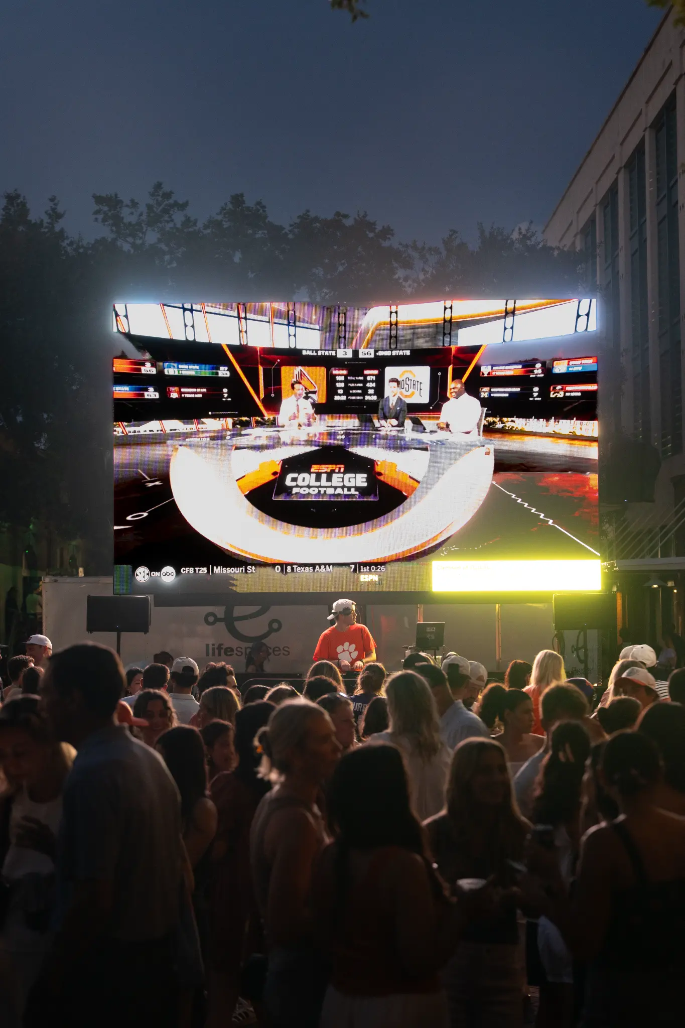 Guests gathered beneath the outdoor football screen in Camden Alley at Share House