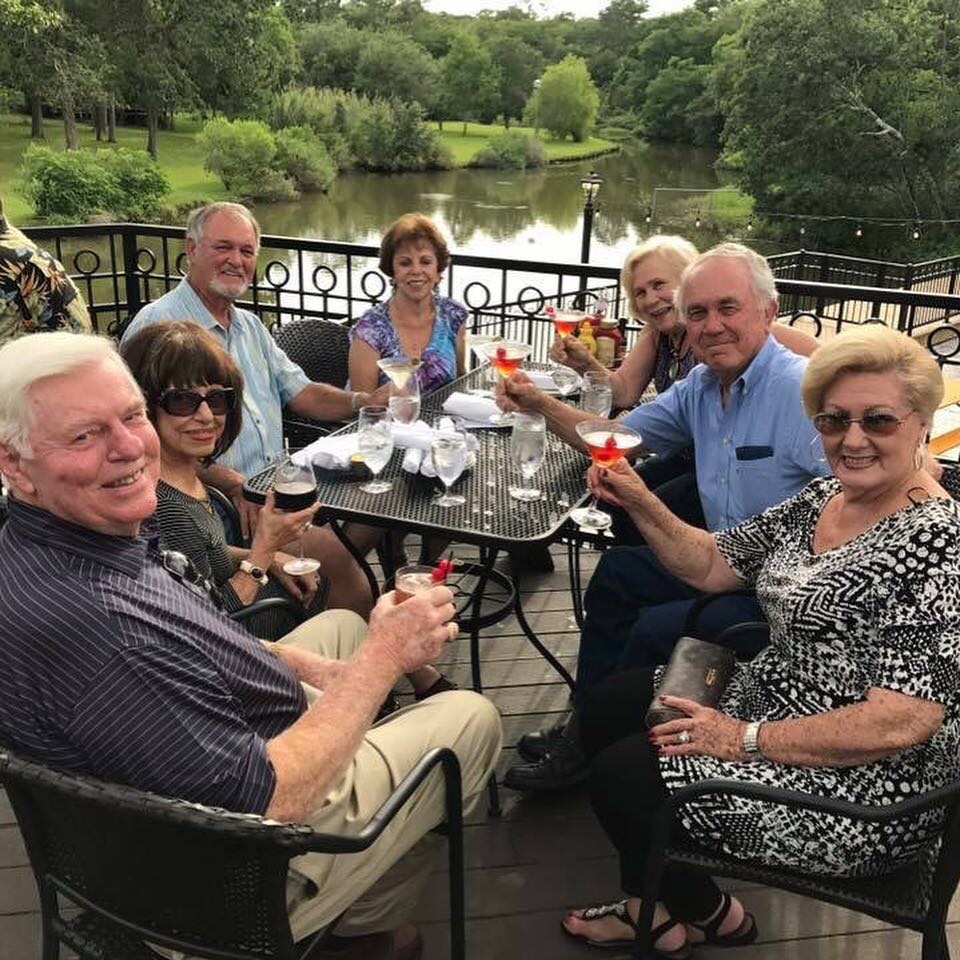 a group of people sitting at a park