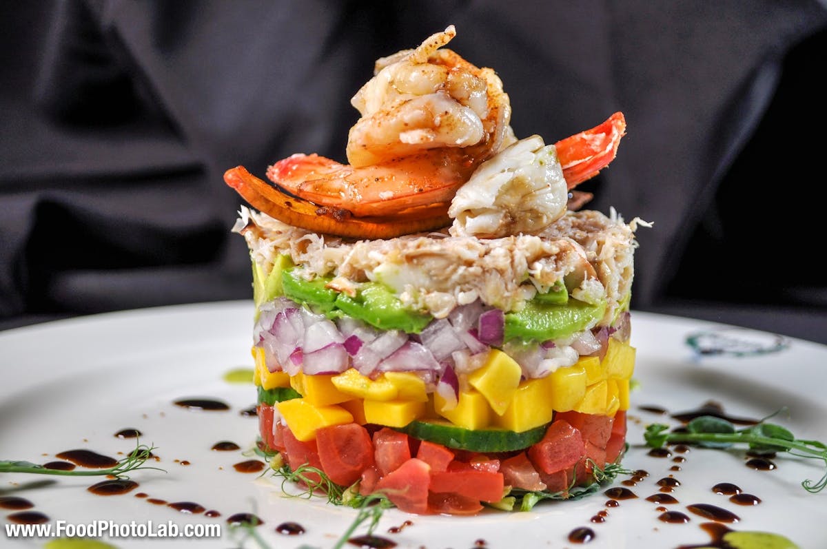 a plate of food with a slice of cake on a table