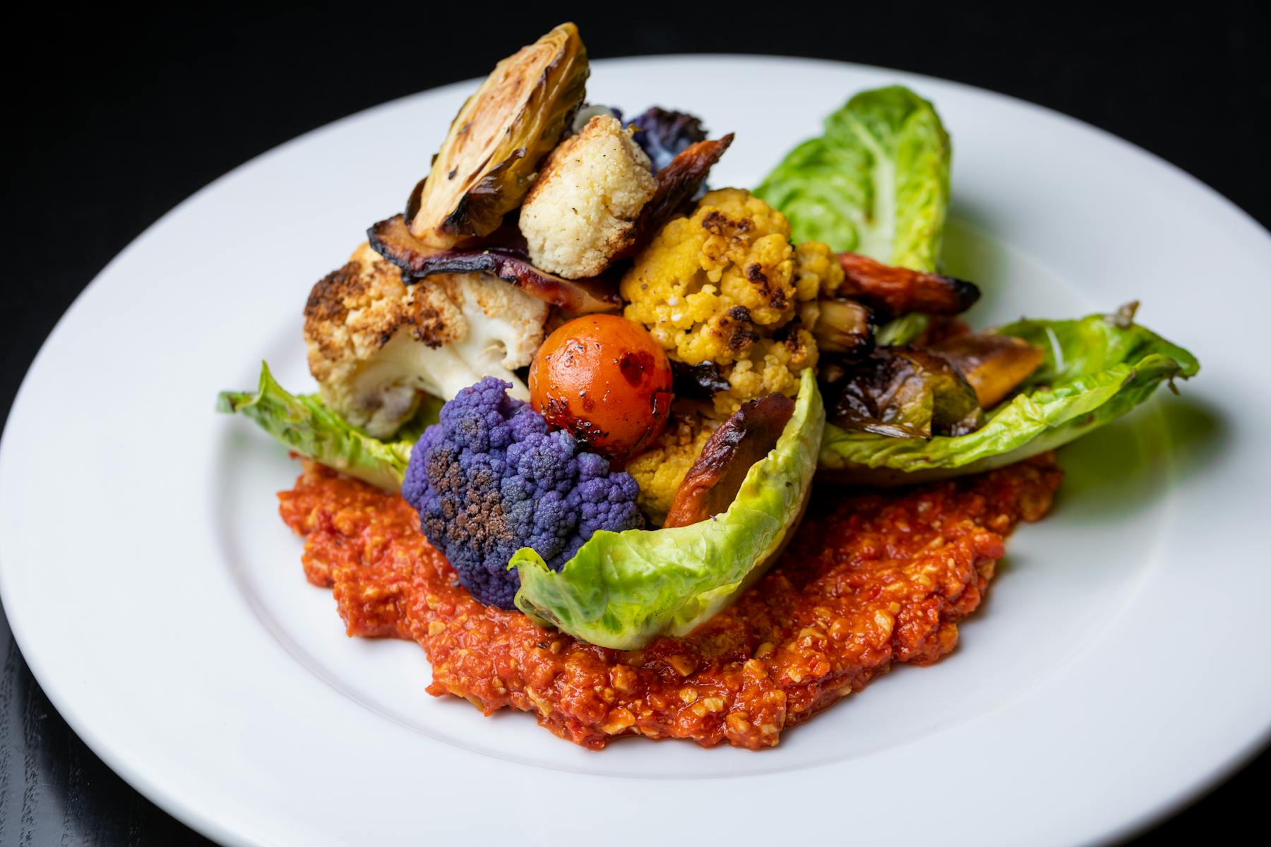 a white plate topped with meat and vegetables