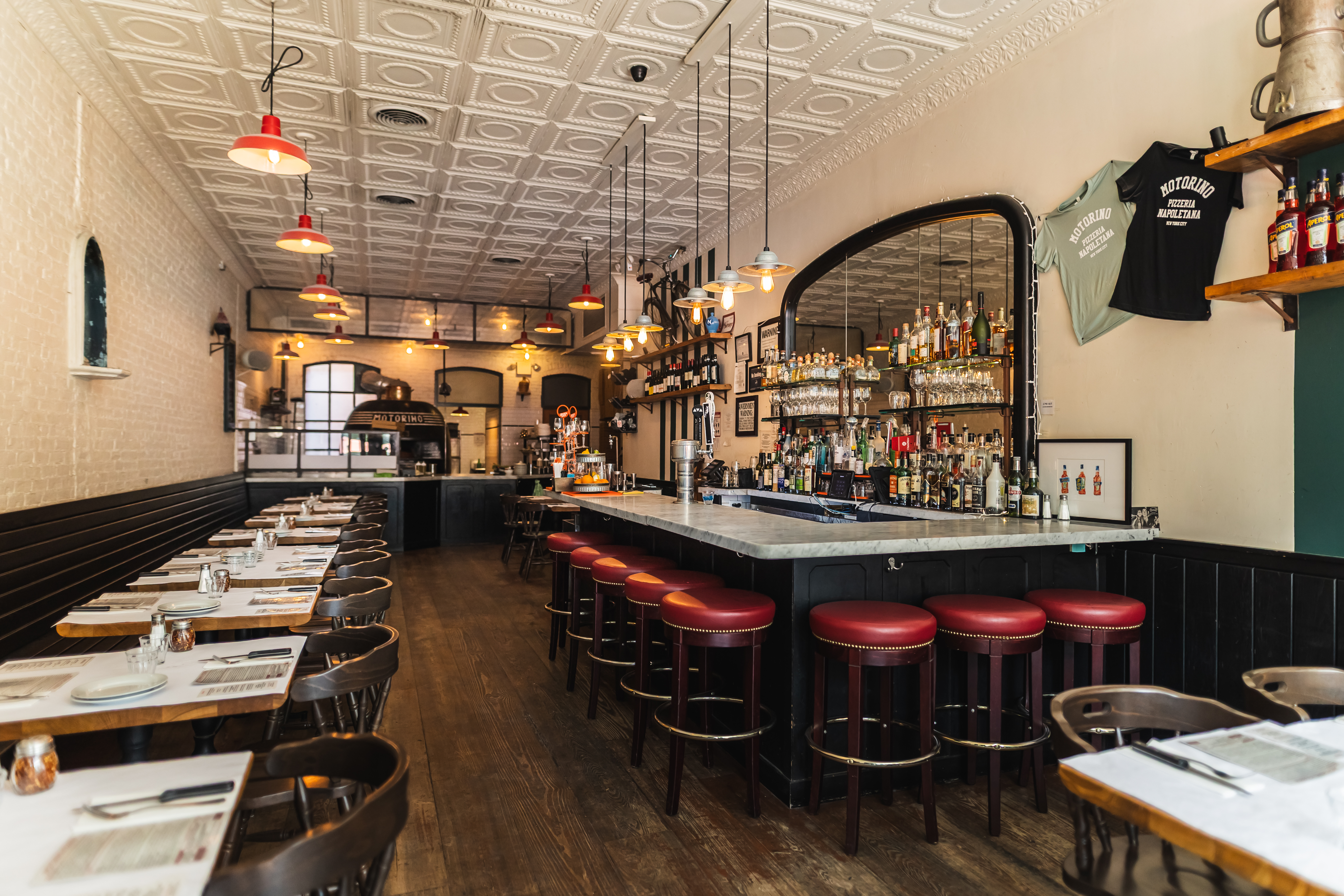 a dining room with a bar and tables and chairs