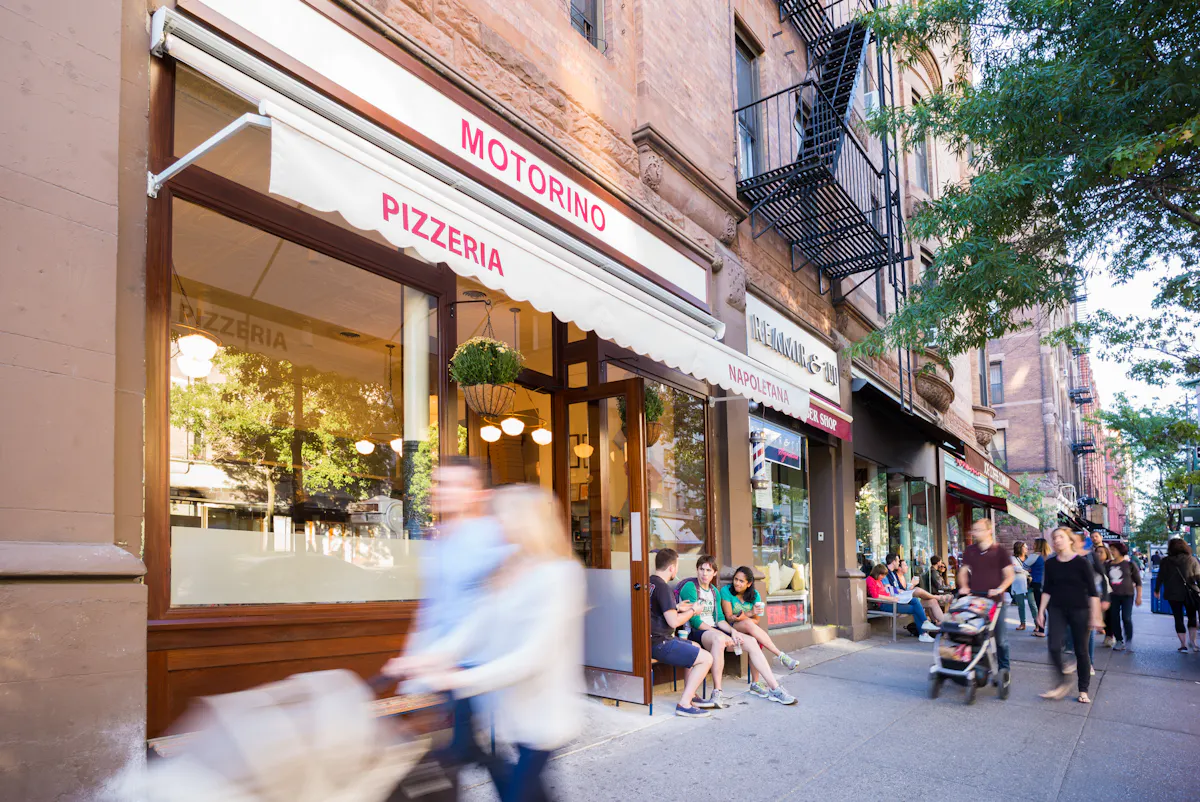 People Walking In Front of Restaurant