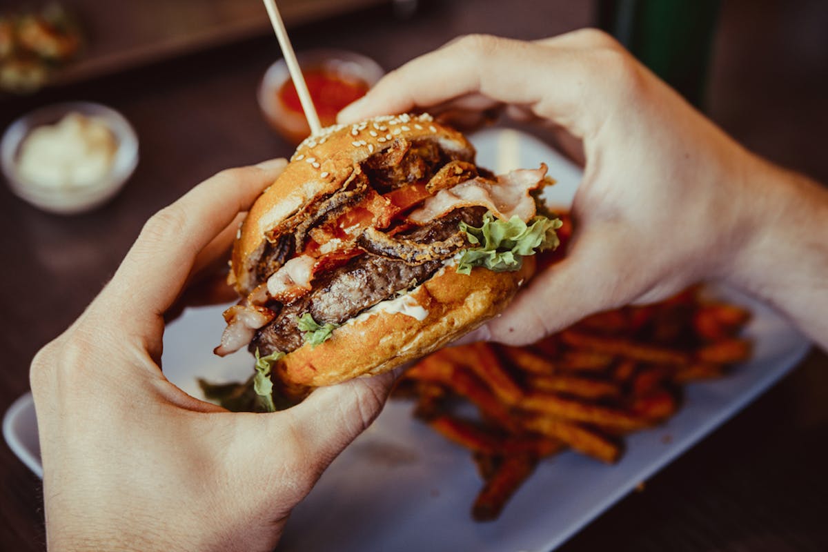 a close up of a person holding a piece of food