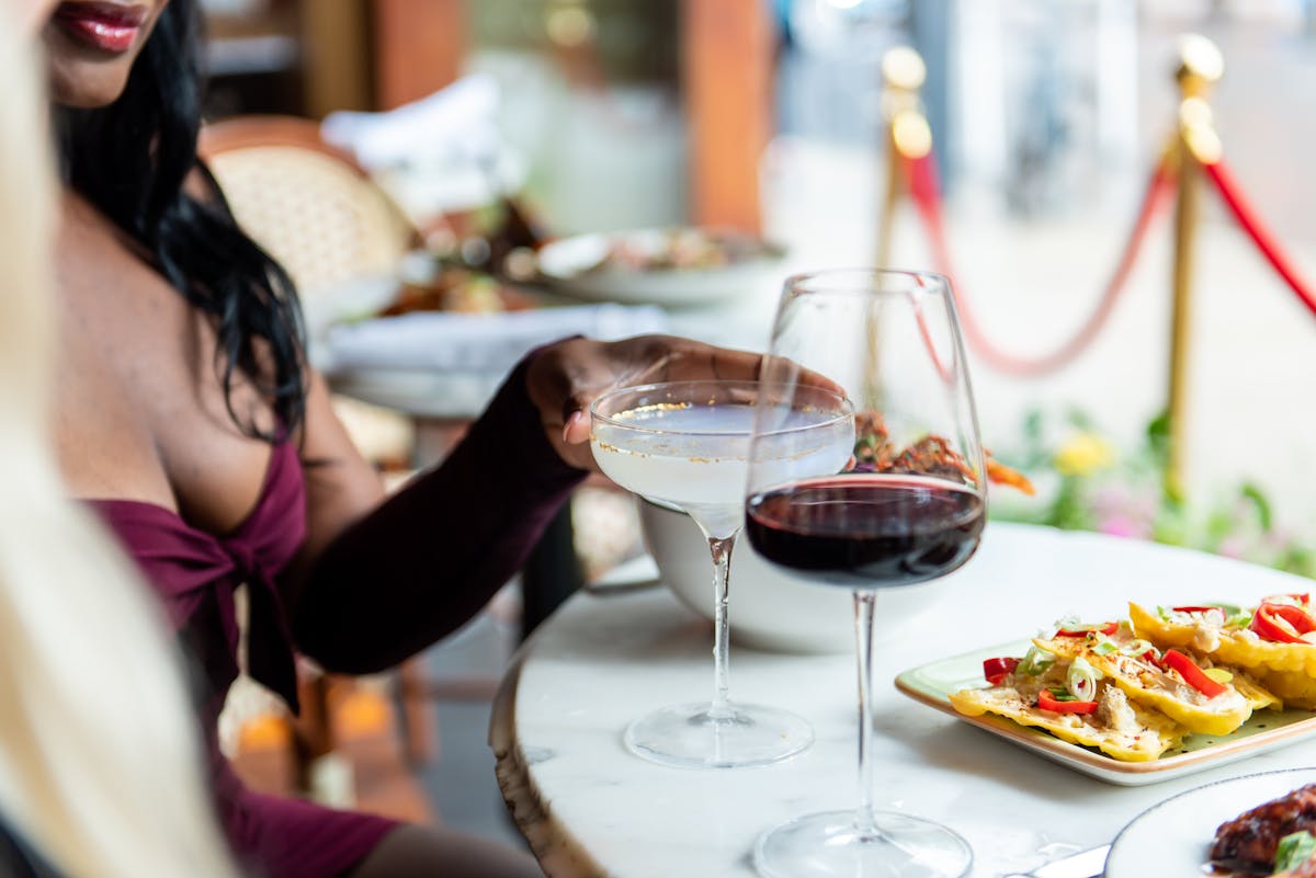 a woman sitting at a table with a plate of food