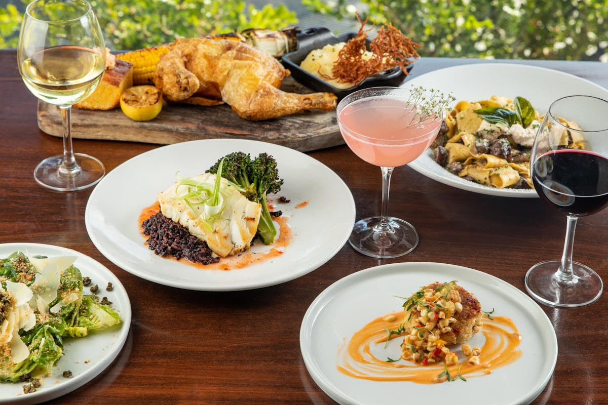 plates of food and a drink sitting on top of a table