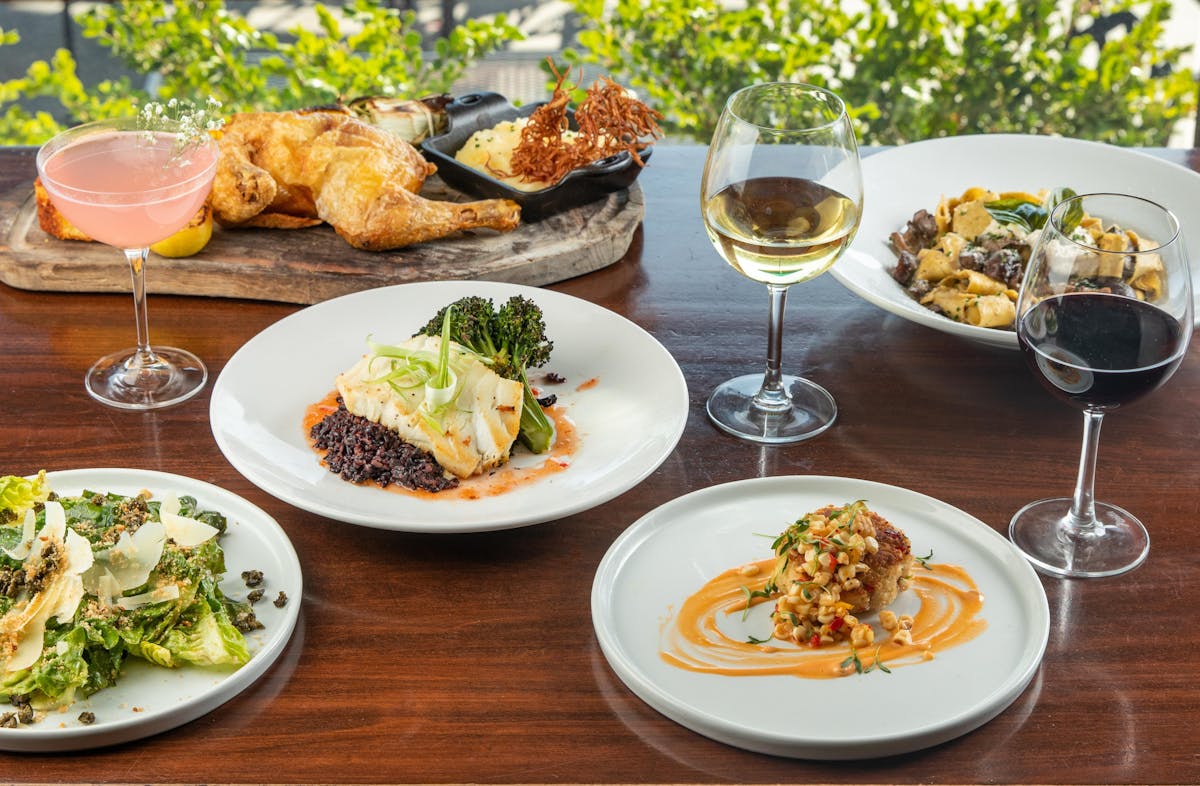 plates of food and glasses of wine on a table