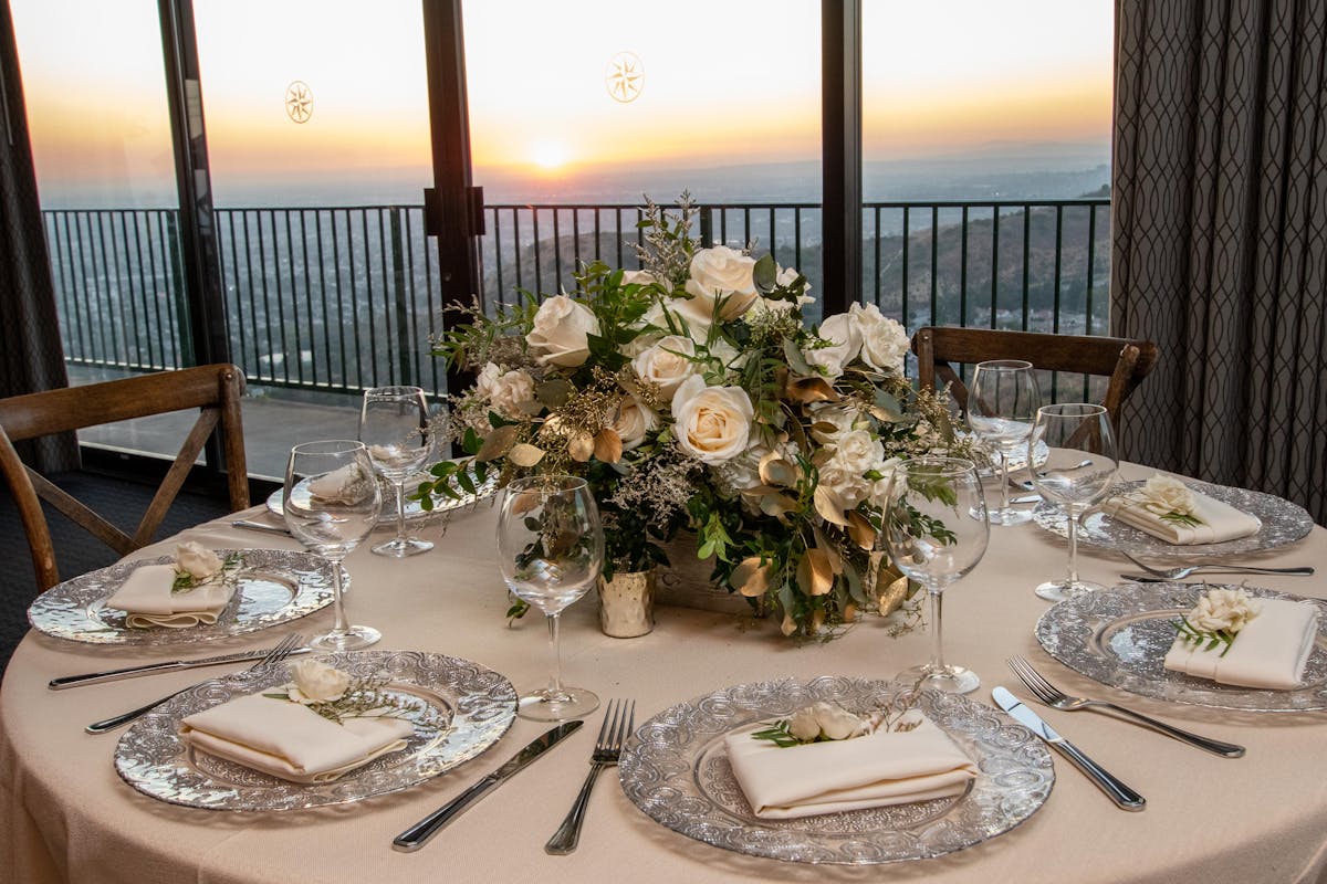 a table with place settings and flowers