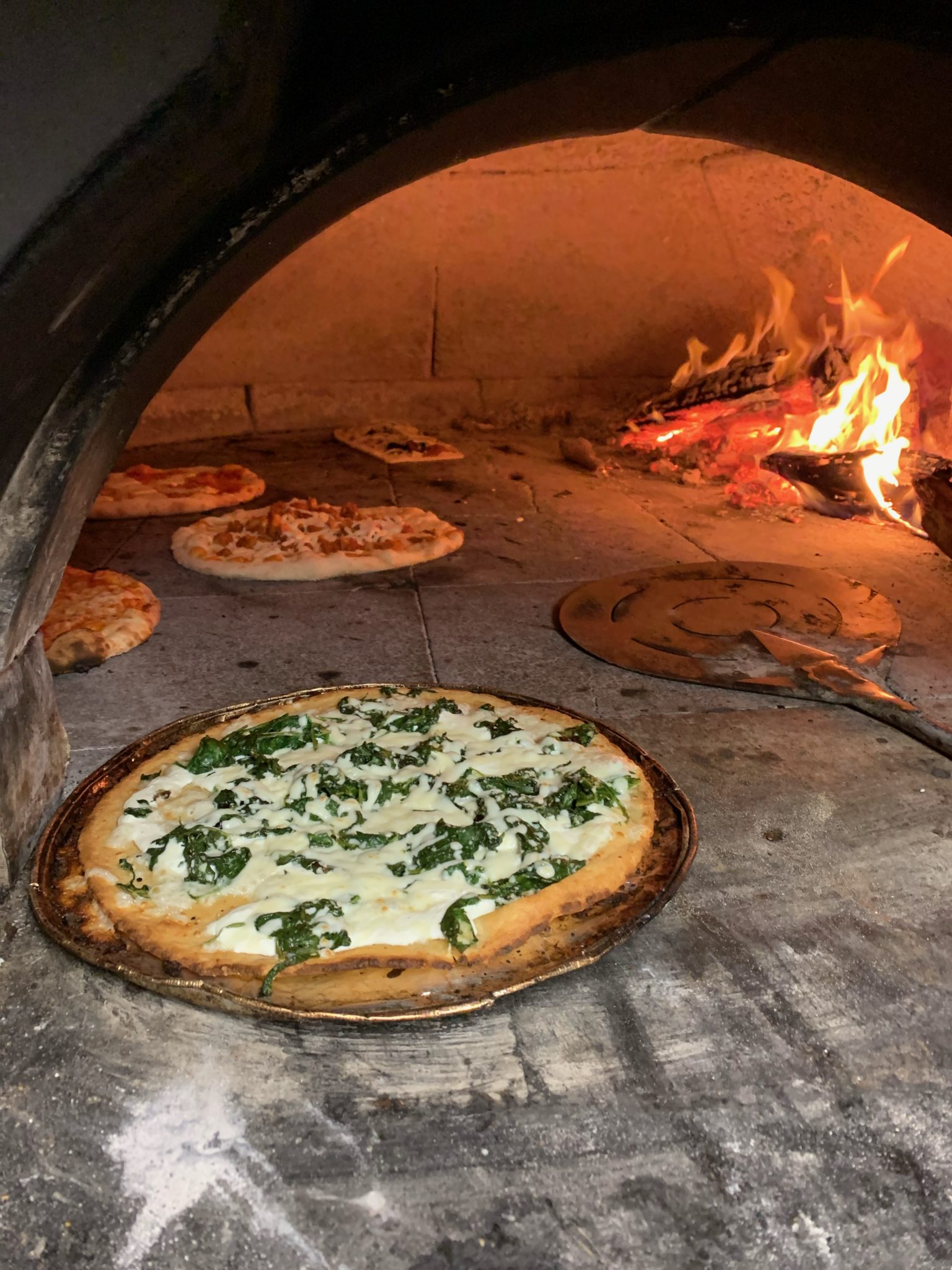 a pizza sitting on top of a stove