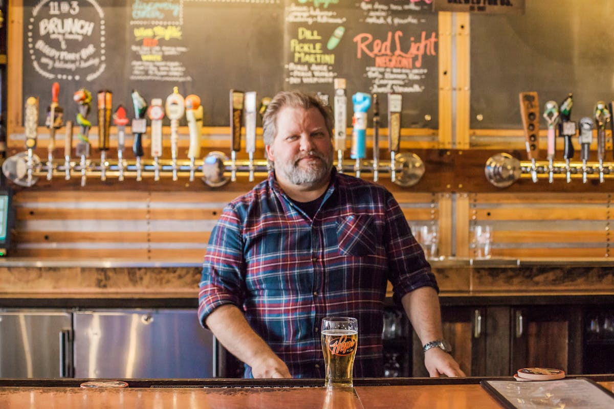 man posing at a bar