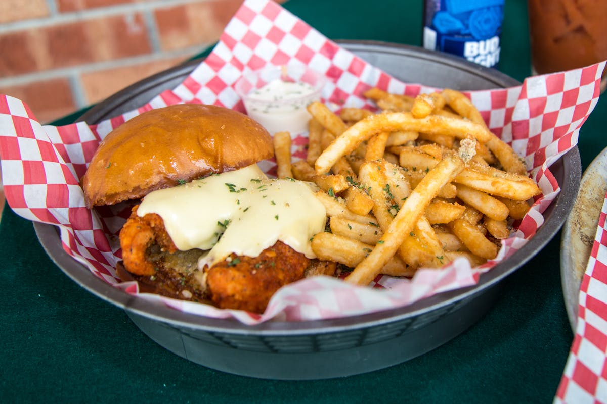 a basket of fries and a sandwich on a plate