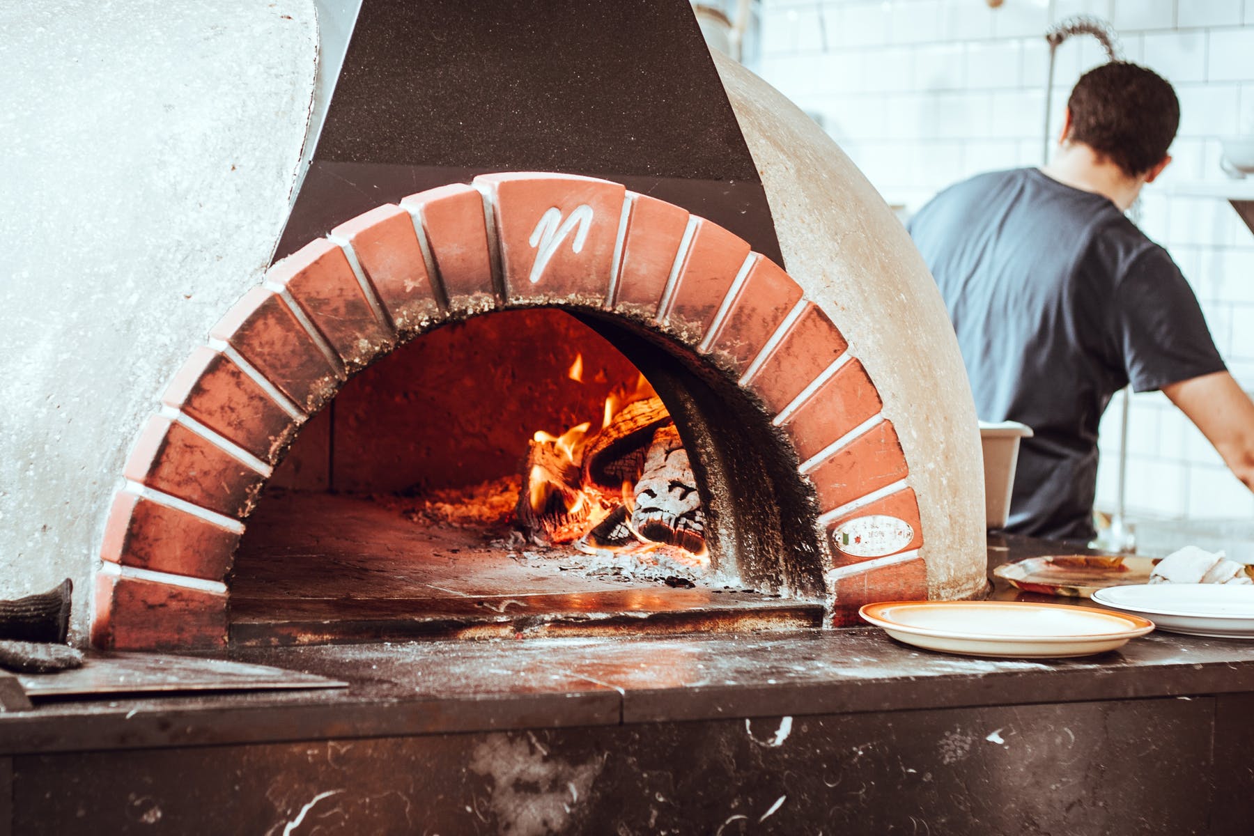 a man cooking pizza
