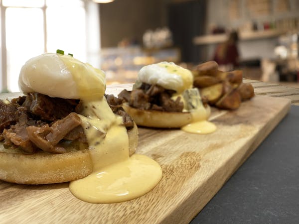 a sandwich sitting on top of a wooden cutting board