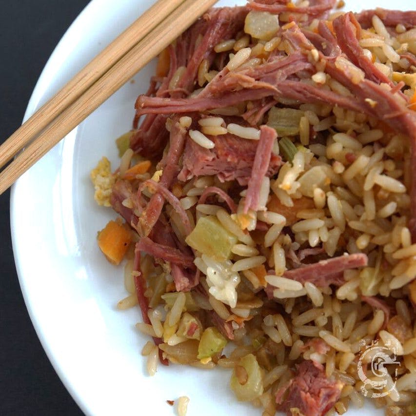 a plate of food with rice meat and vegetables