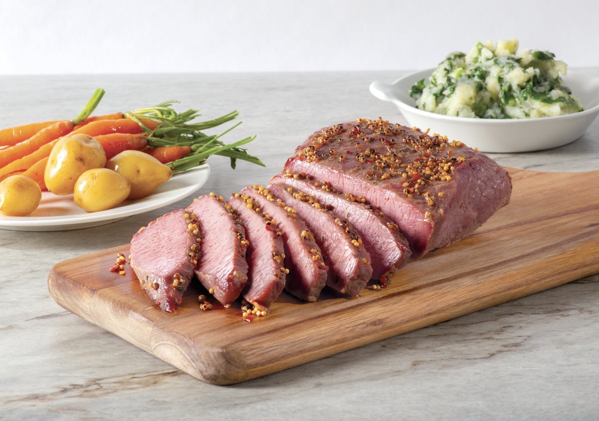 a plate of food sitting on top of a wooden cutting board