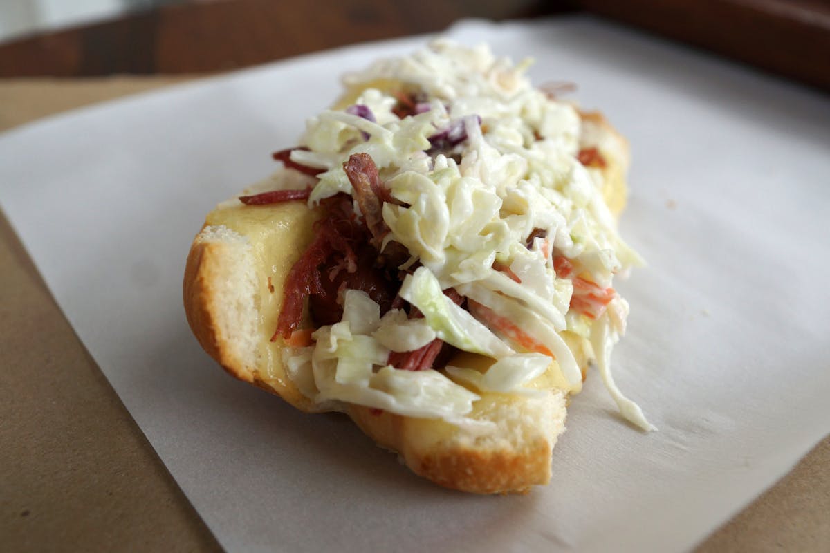a close up of a dinty moore hot dog on a table.