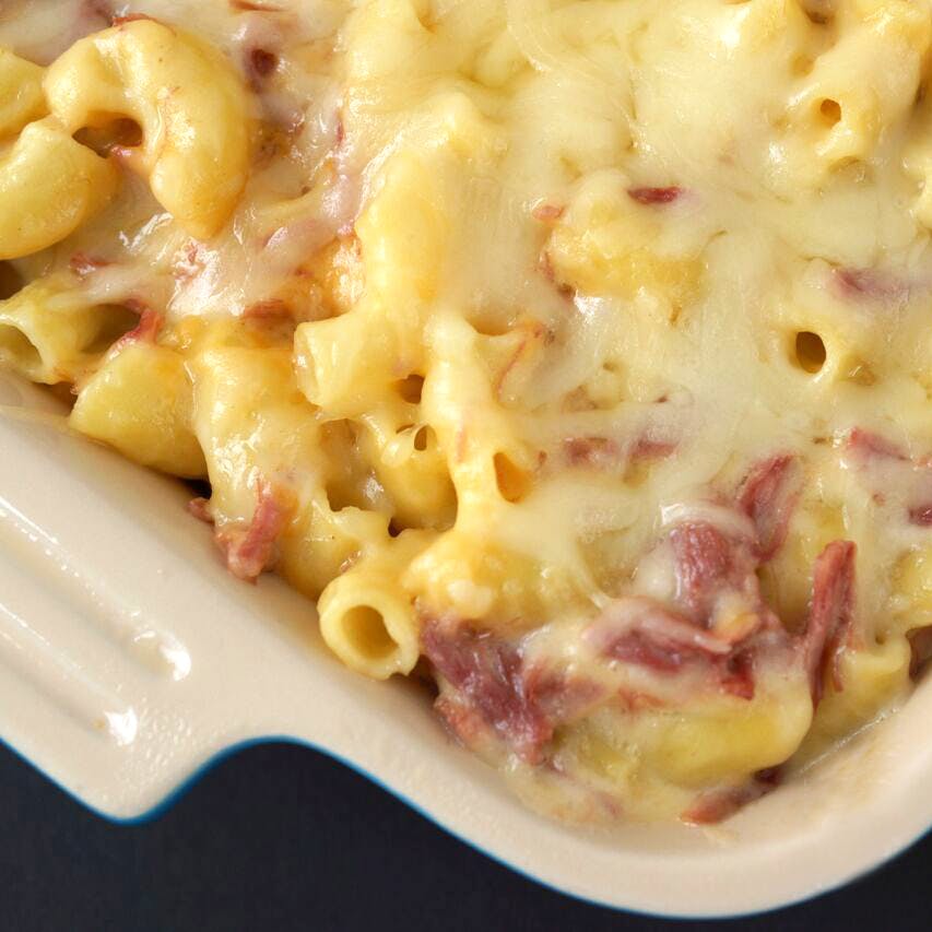 a close up of a plate of pasta with sauce and cheese