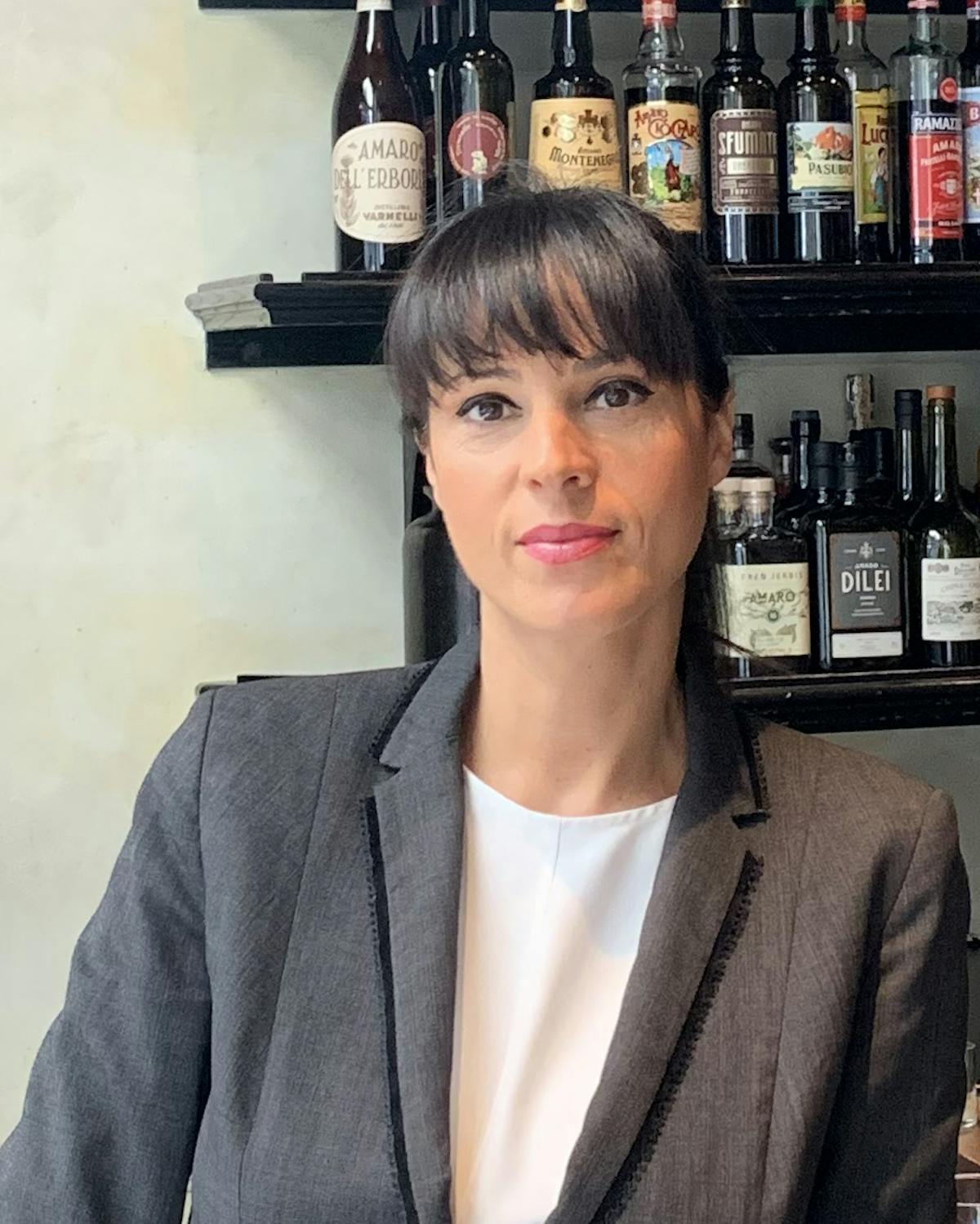 a person wearing glasses and a bottle of wine