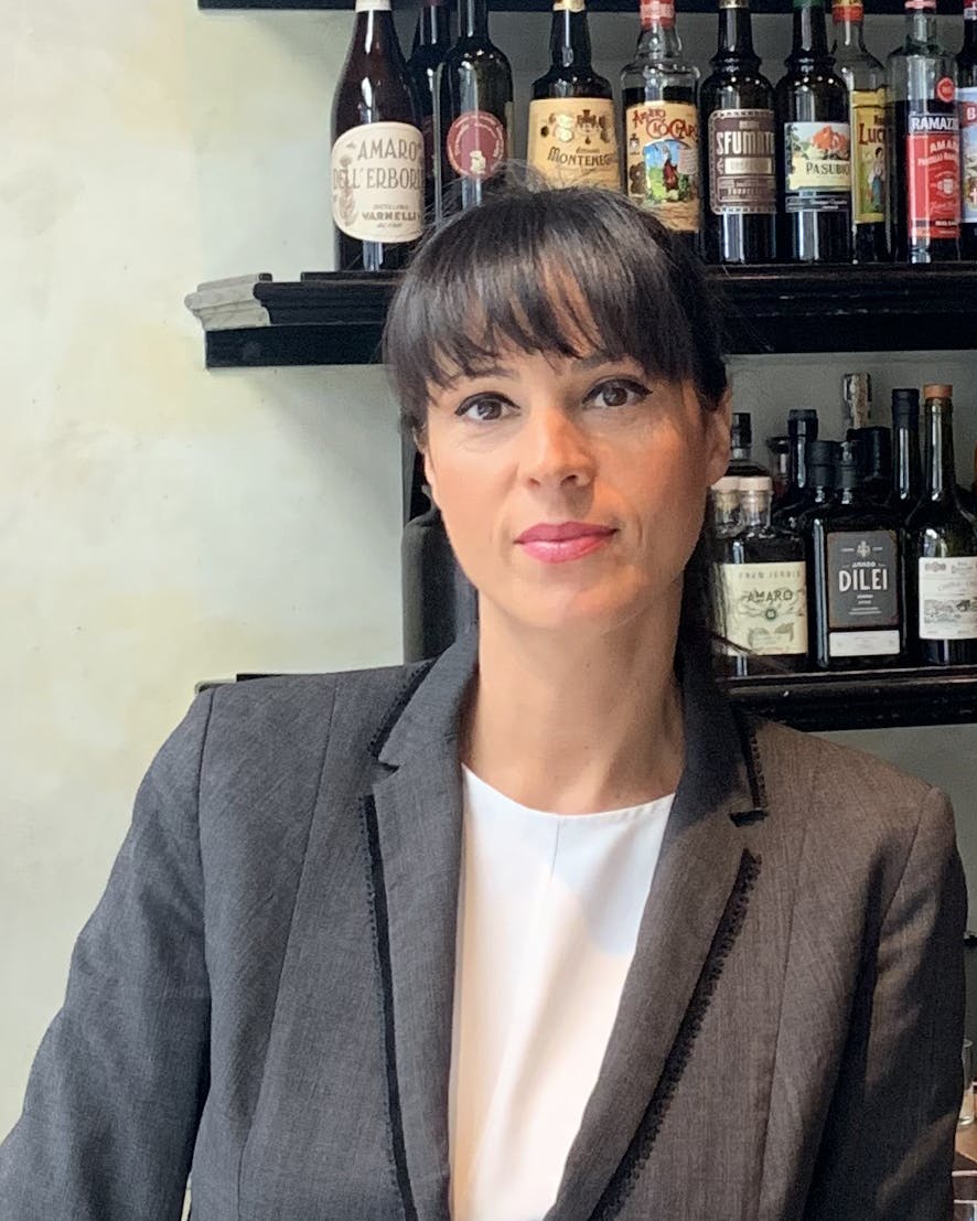 a person wearing glasses and a bottle of wine