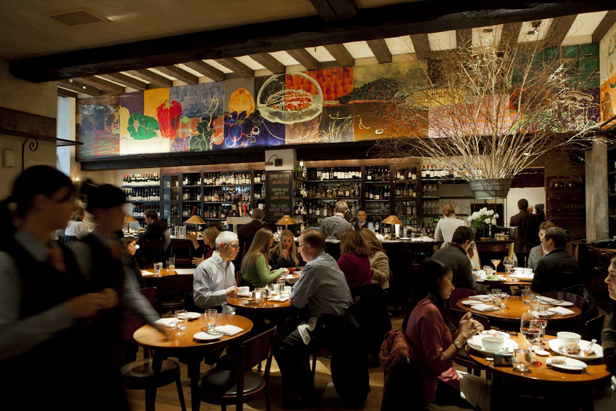 a group of people sitting at a table in a restaurant