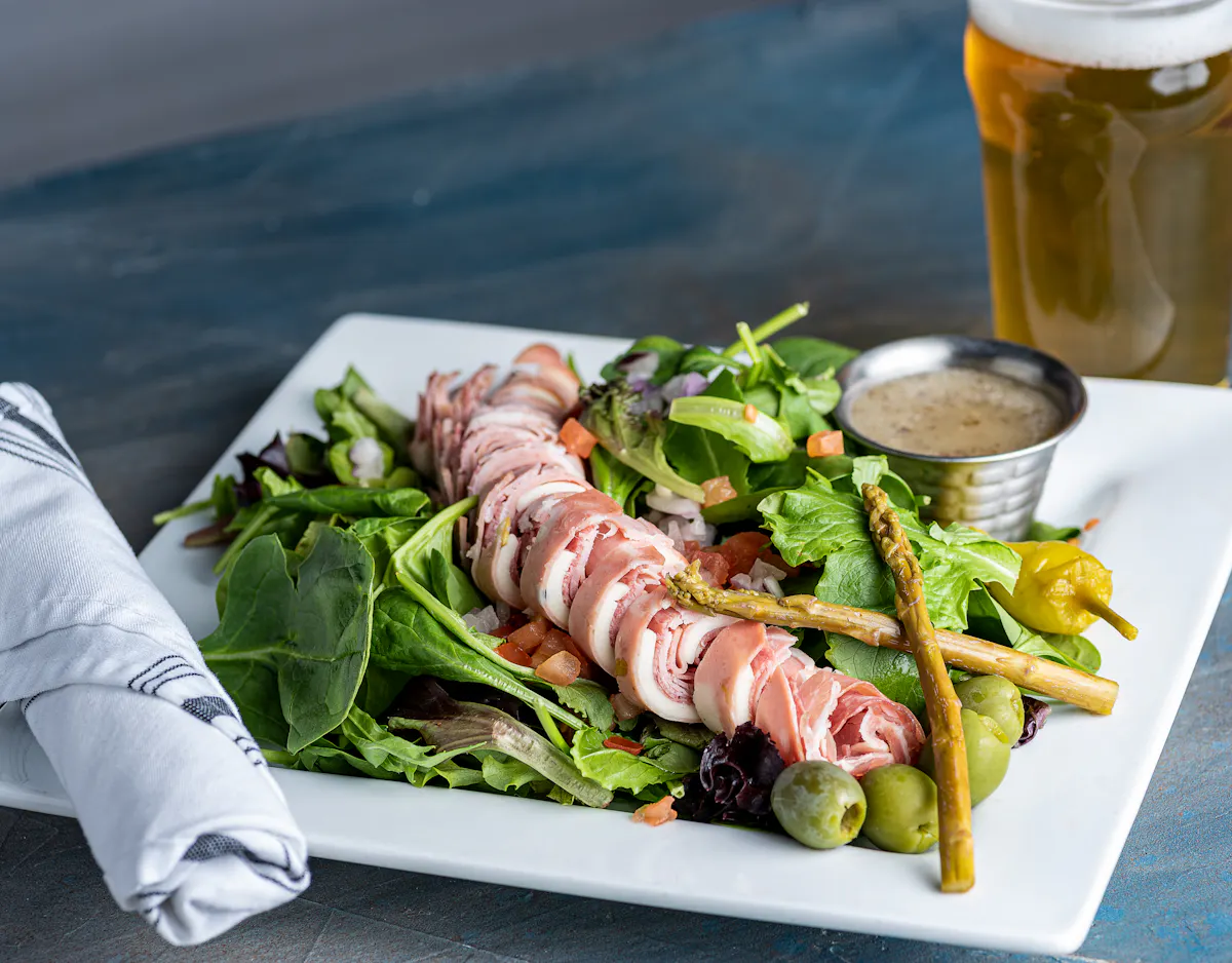 a plate of food with a sandwich and a salad