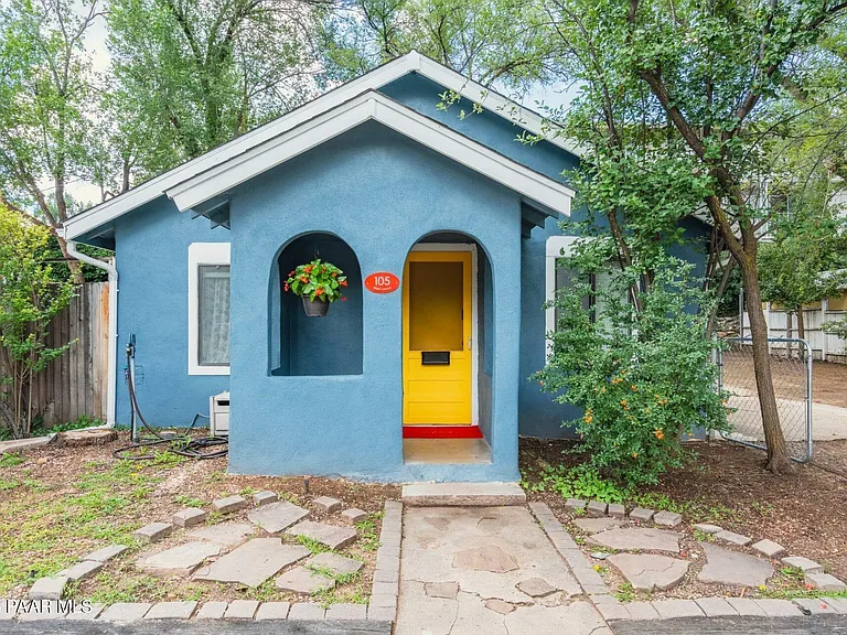 a parking meter in front of a house