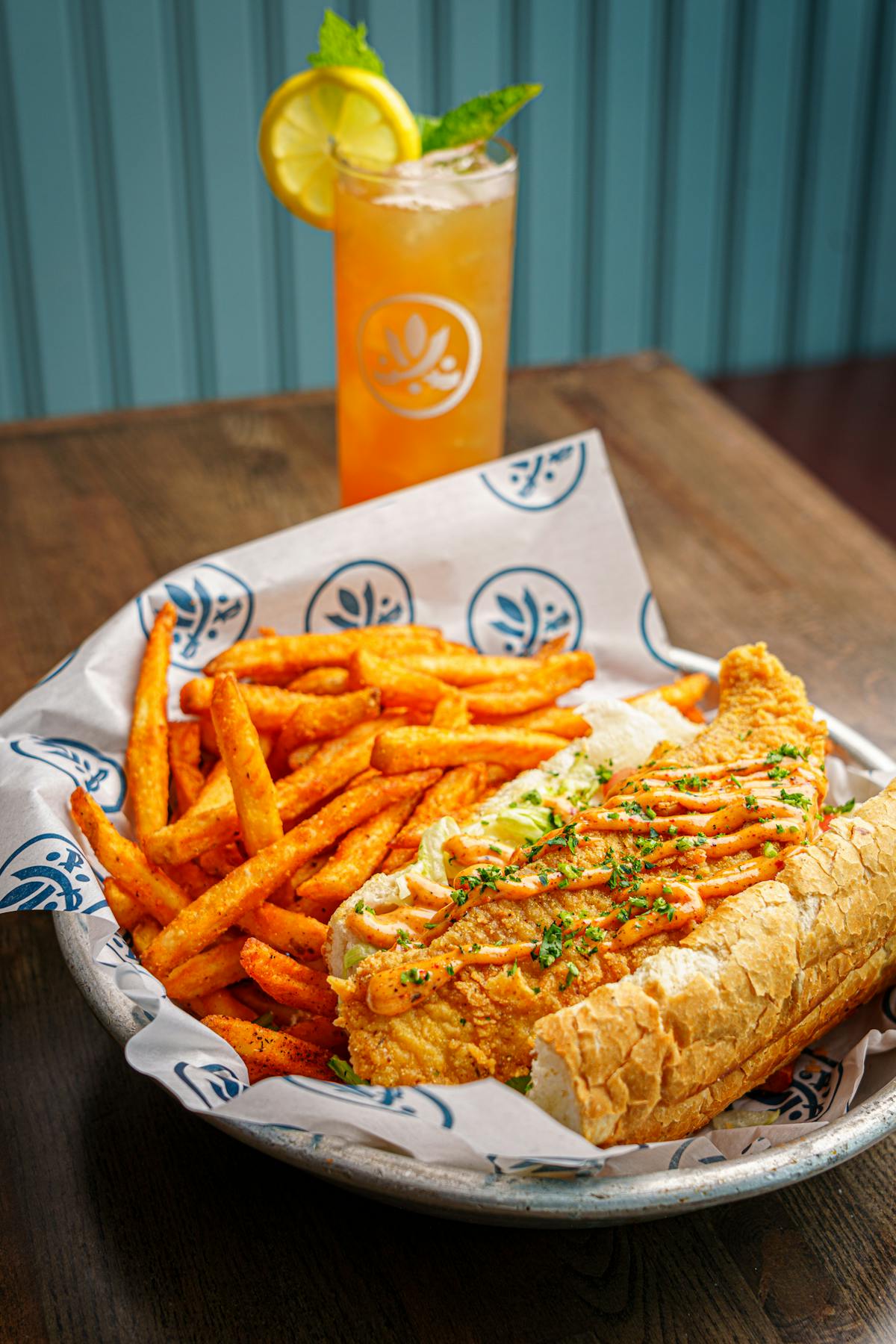 a plate of food with a sandwich and fries on a table