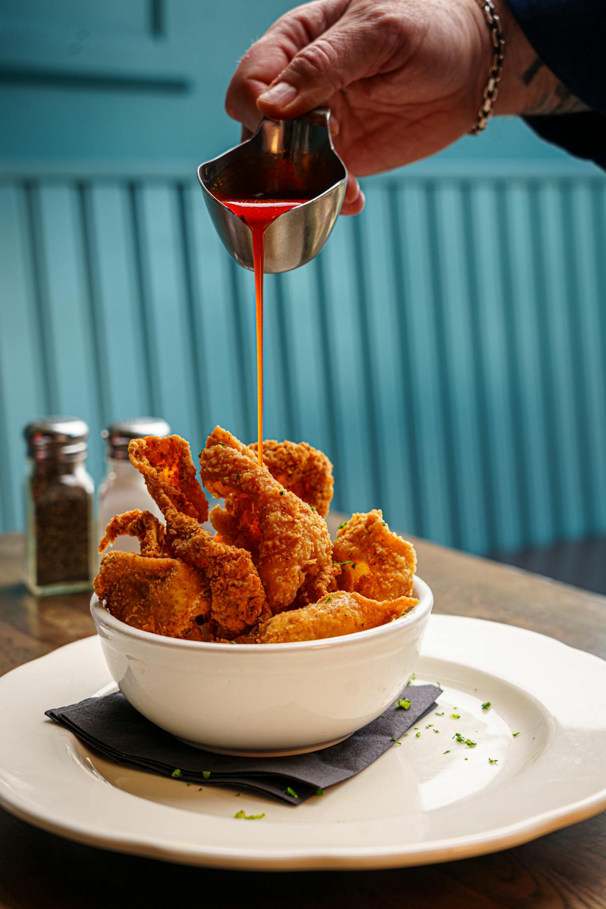 a person sitting at a table with a plate of food