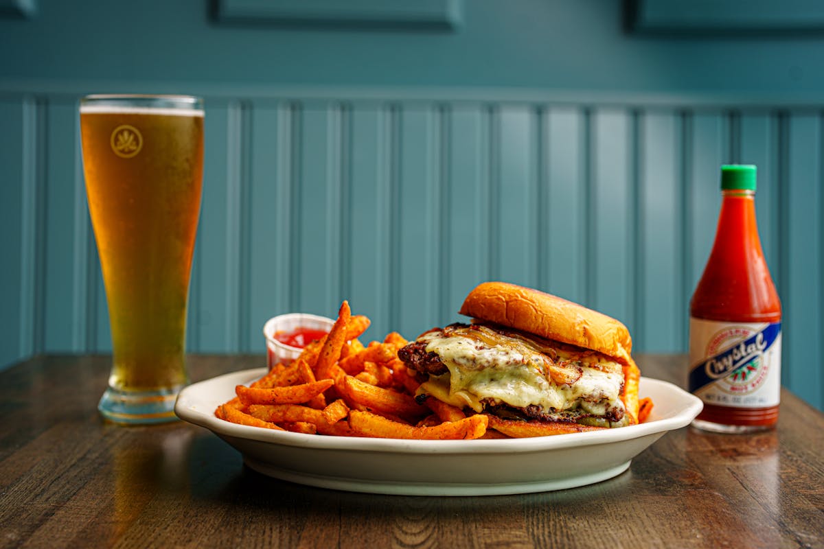 a plate of food and a glass of beer on a table