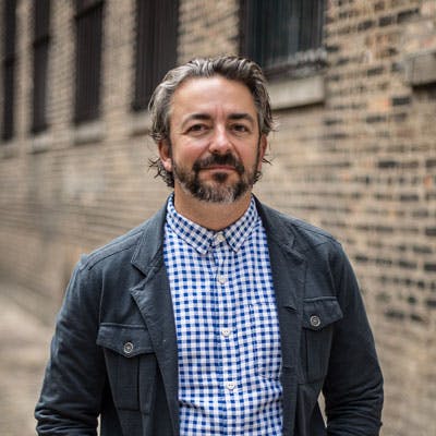 matthias merges standing in front of a brick building