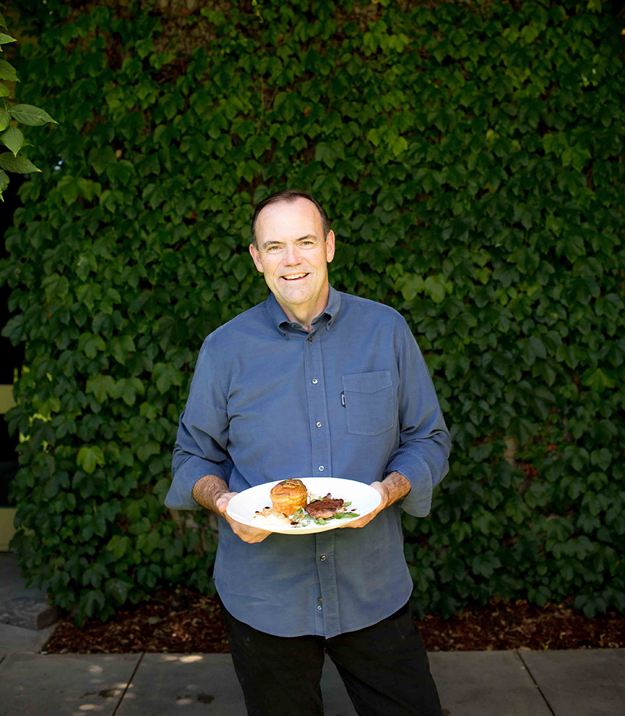 Charlie Palmer holding a hot dog
