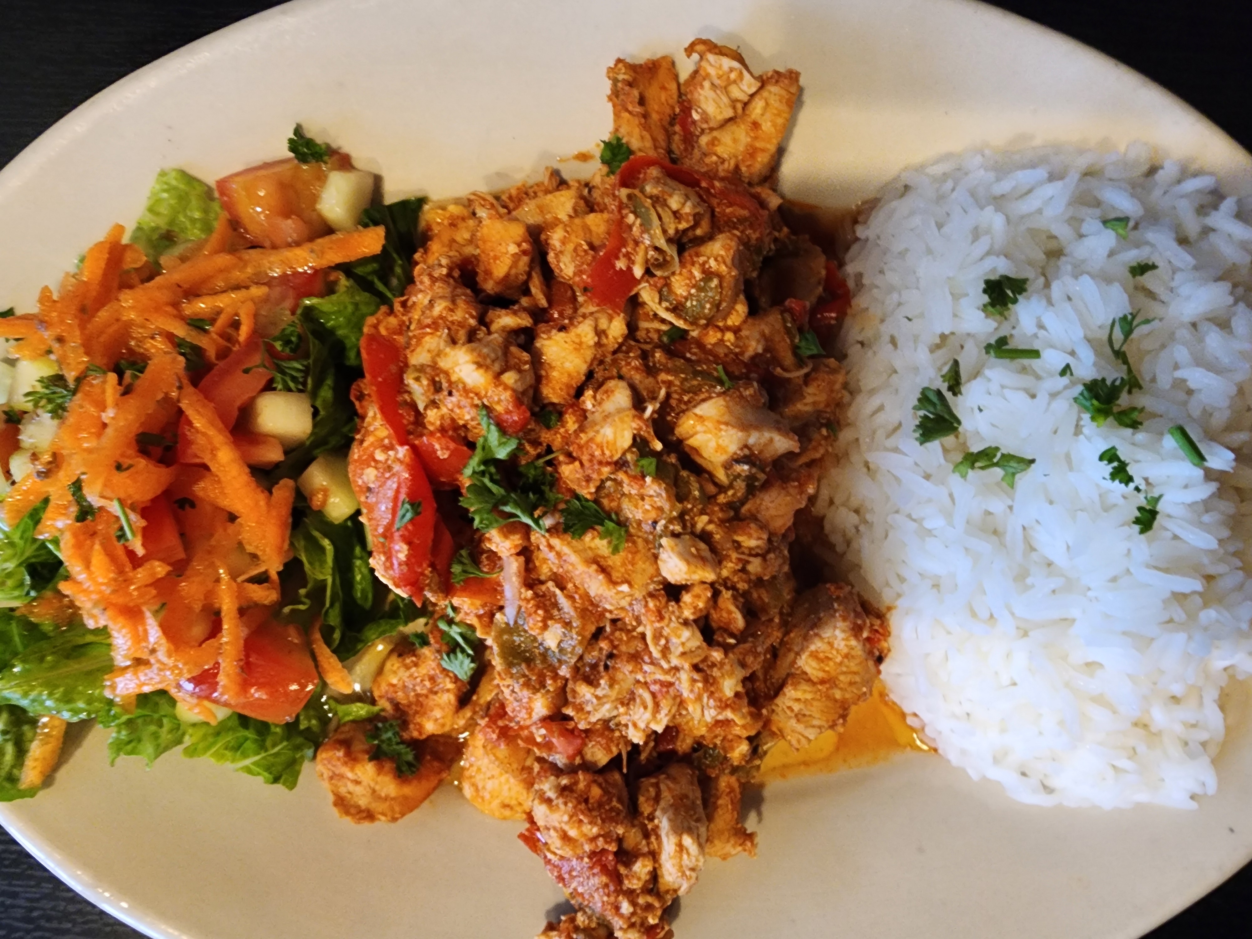 a plate of food with rice meat and vegetables