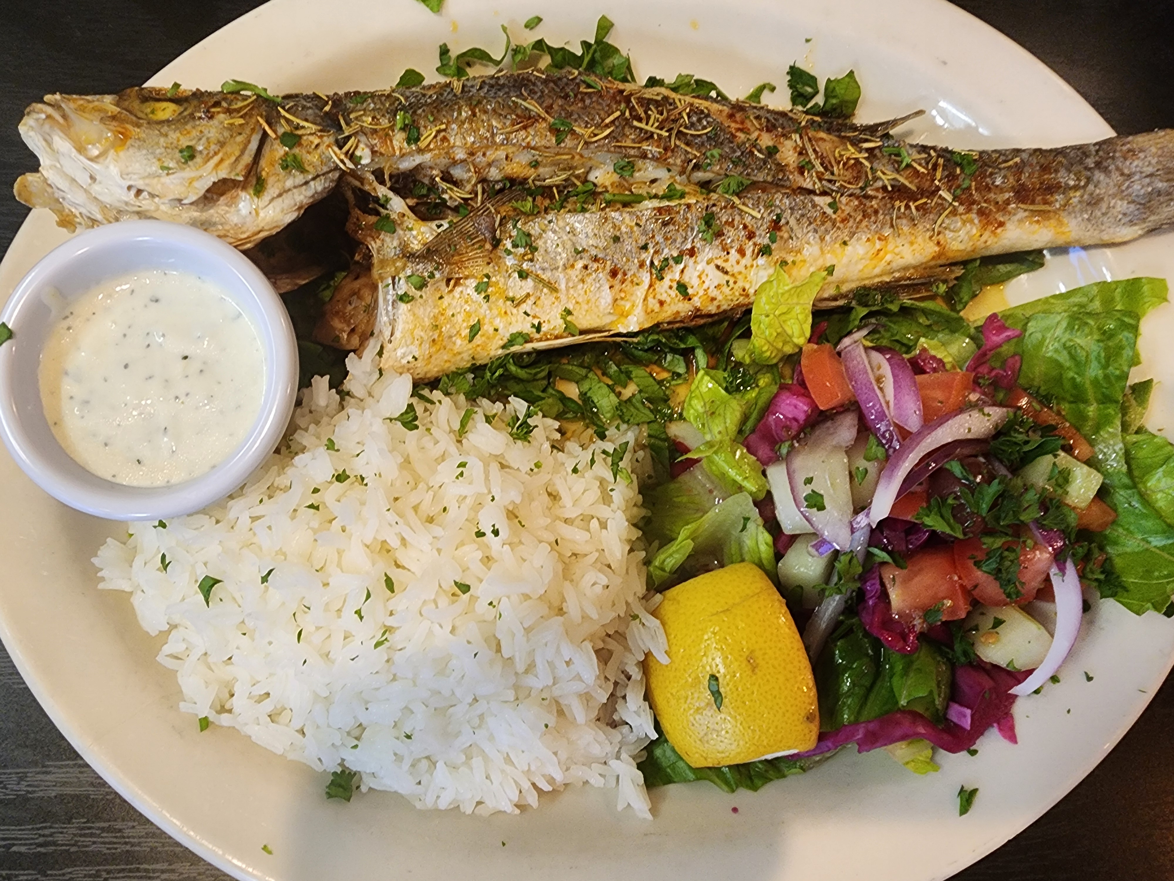 a plate of food with rice meat and vegetables
