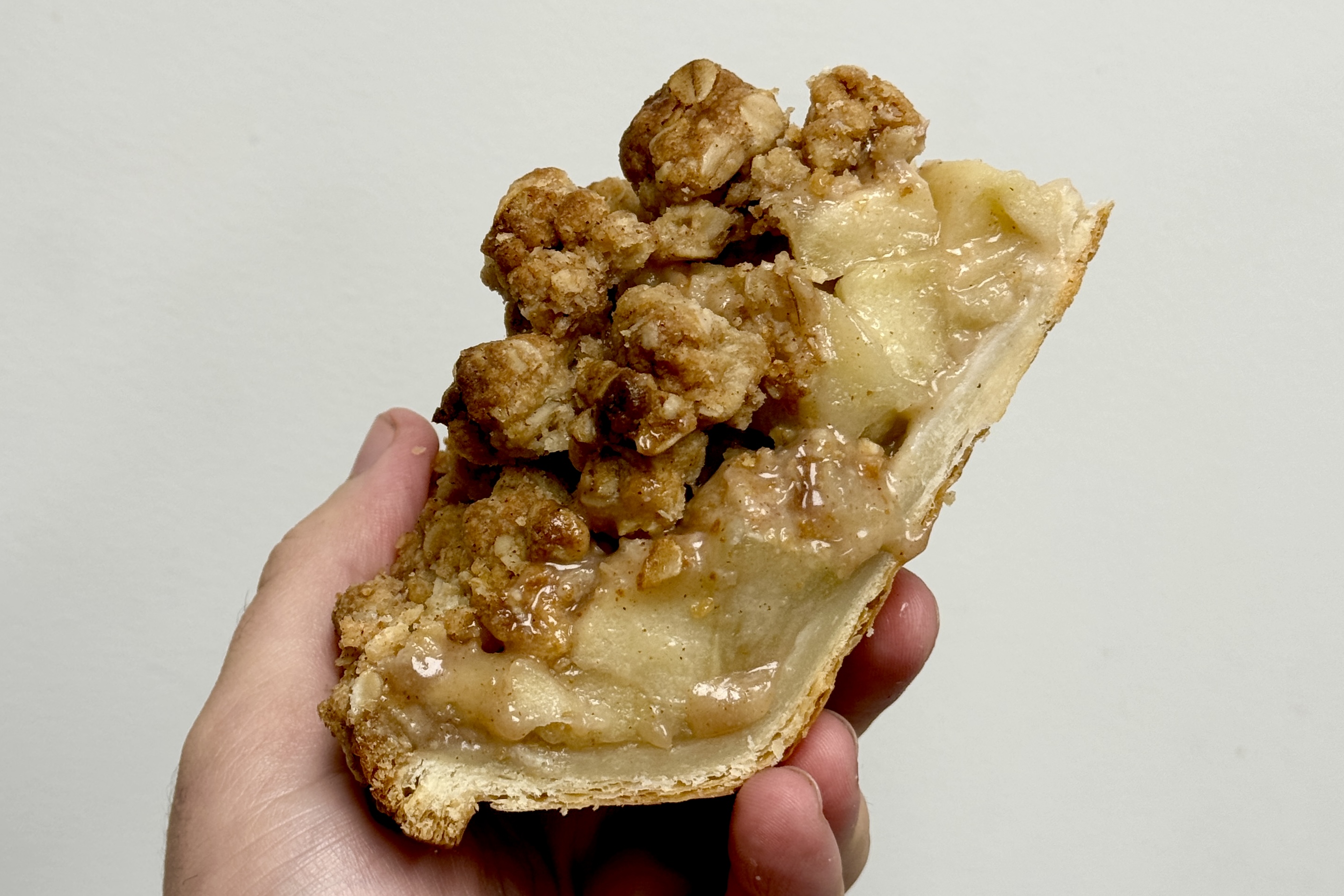 a hand holding a half eaten banana