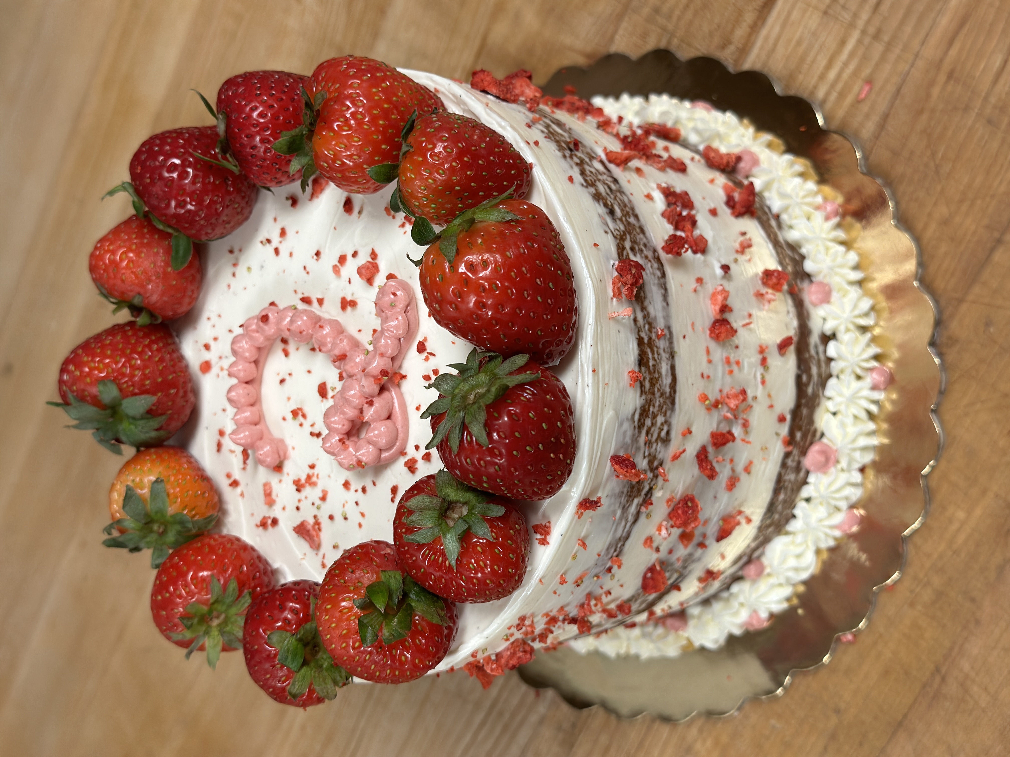 a cake with fruit on top of a wooden table