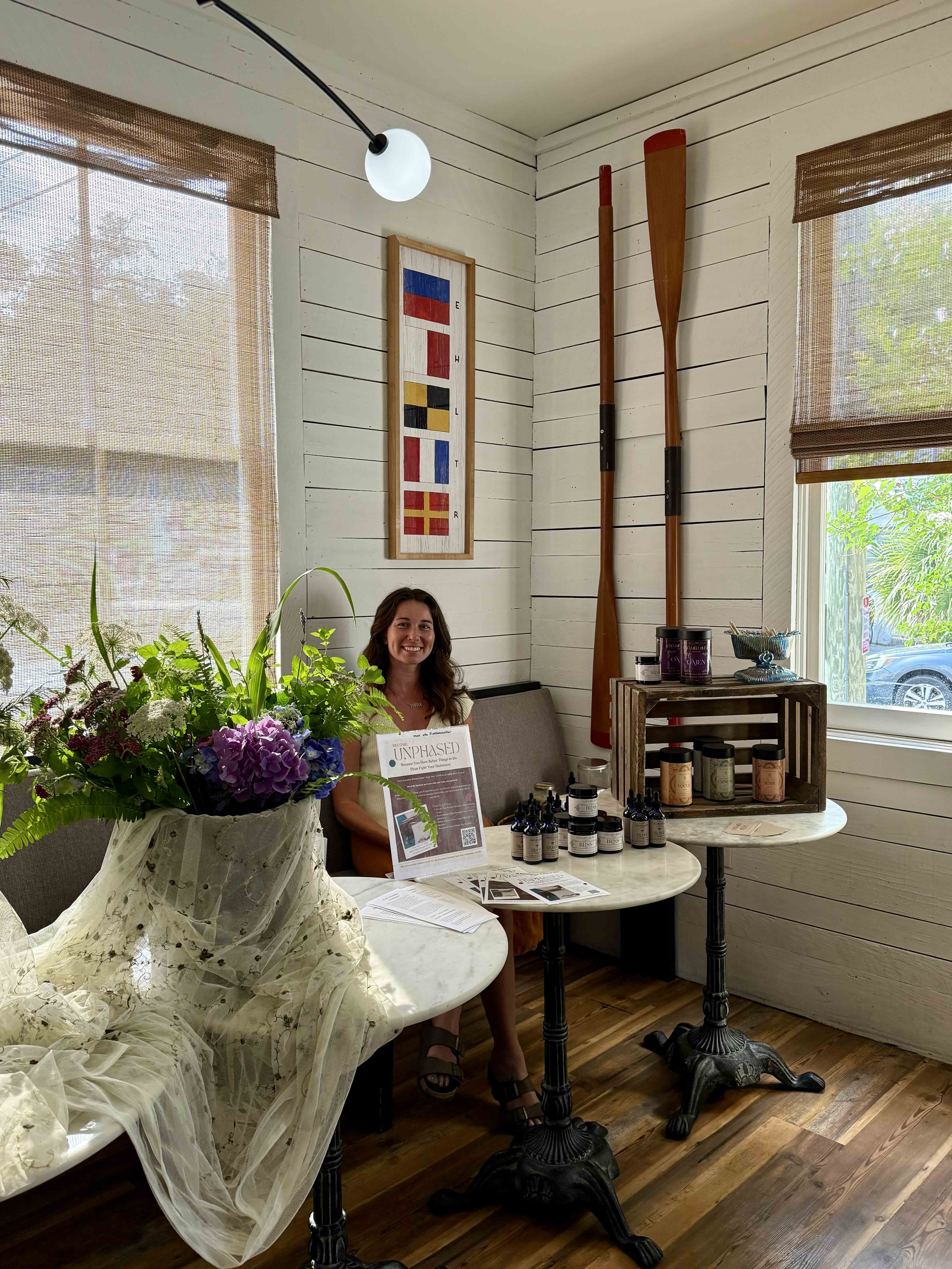a room filled with furniture and vase of flowers on a table