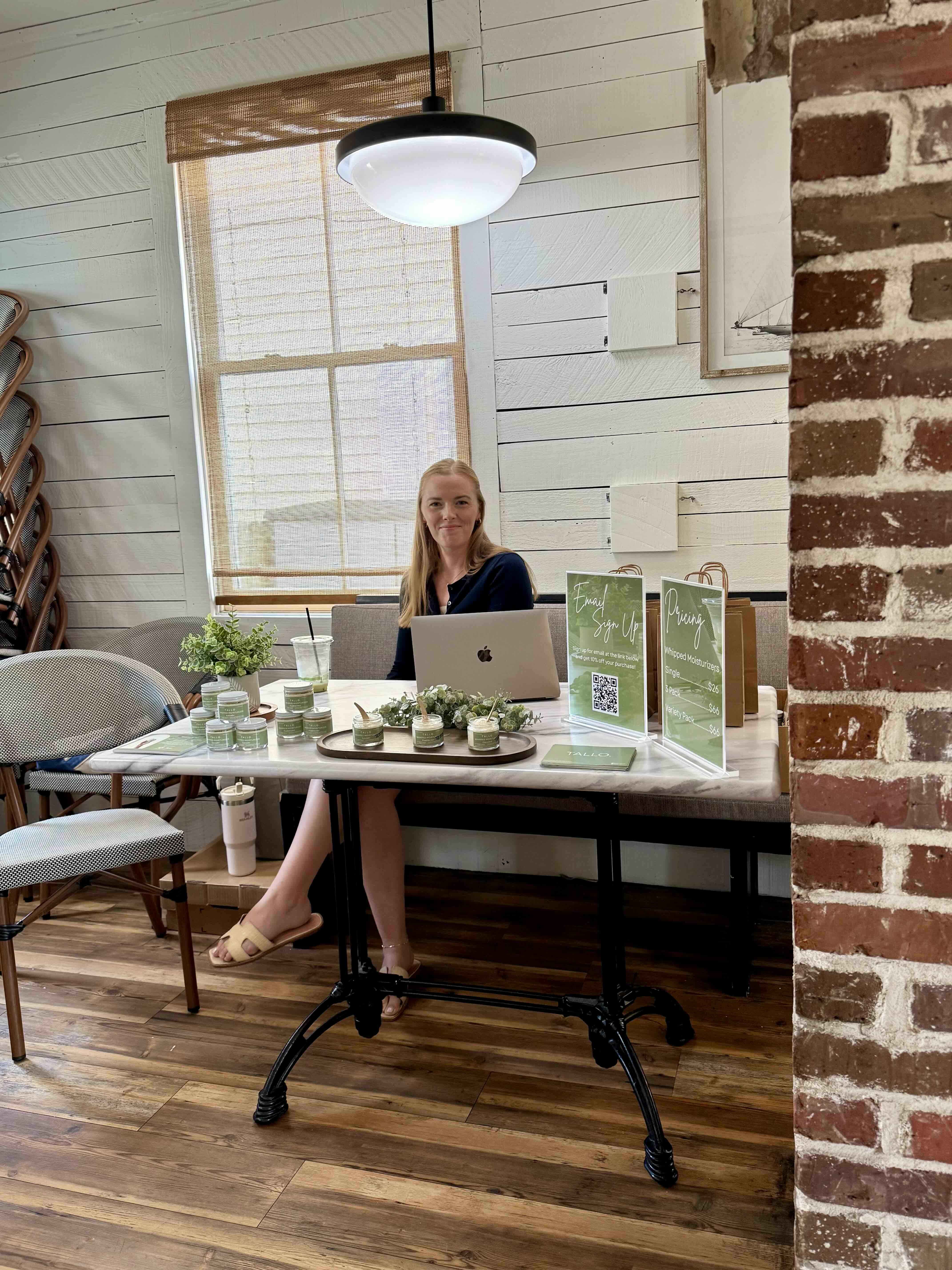 a person sitting at a table in front of a window