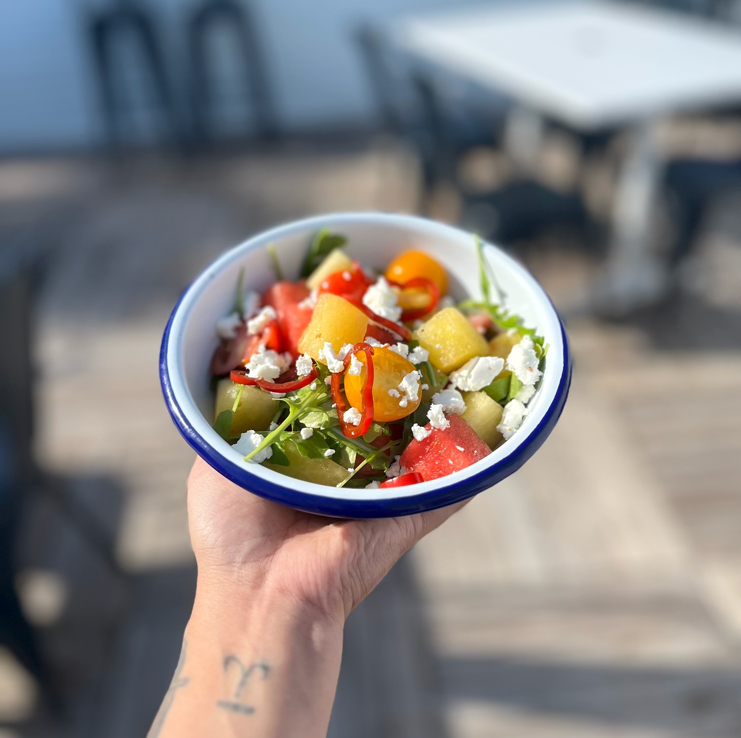 a person holding a bowl of food