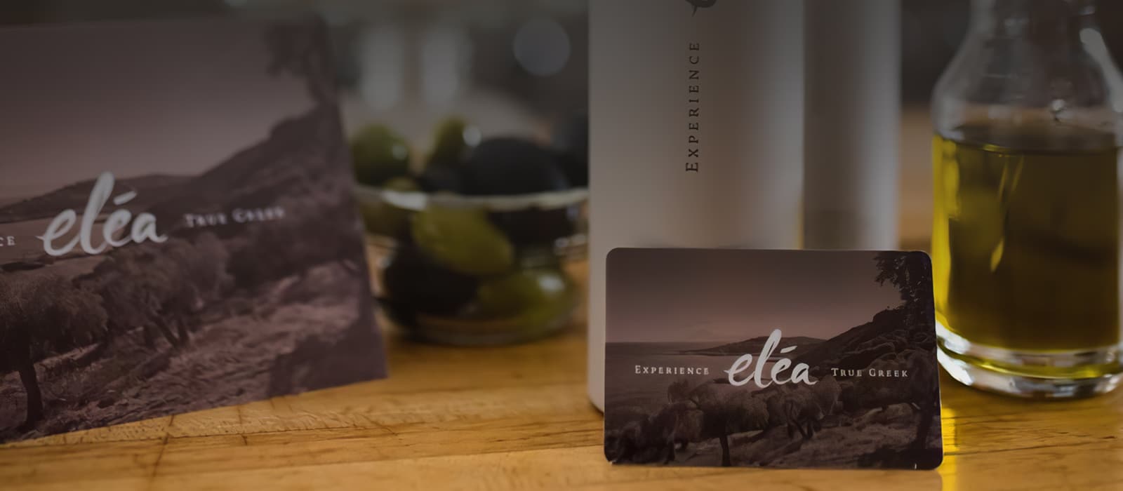 a glass of wine sitting on top of a wooden table